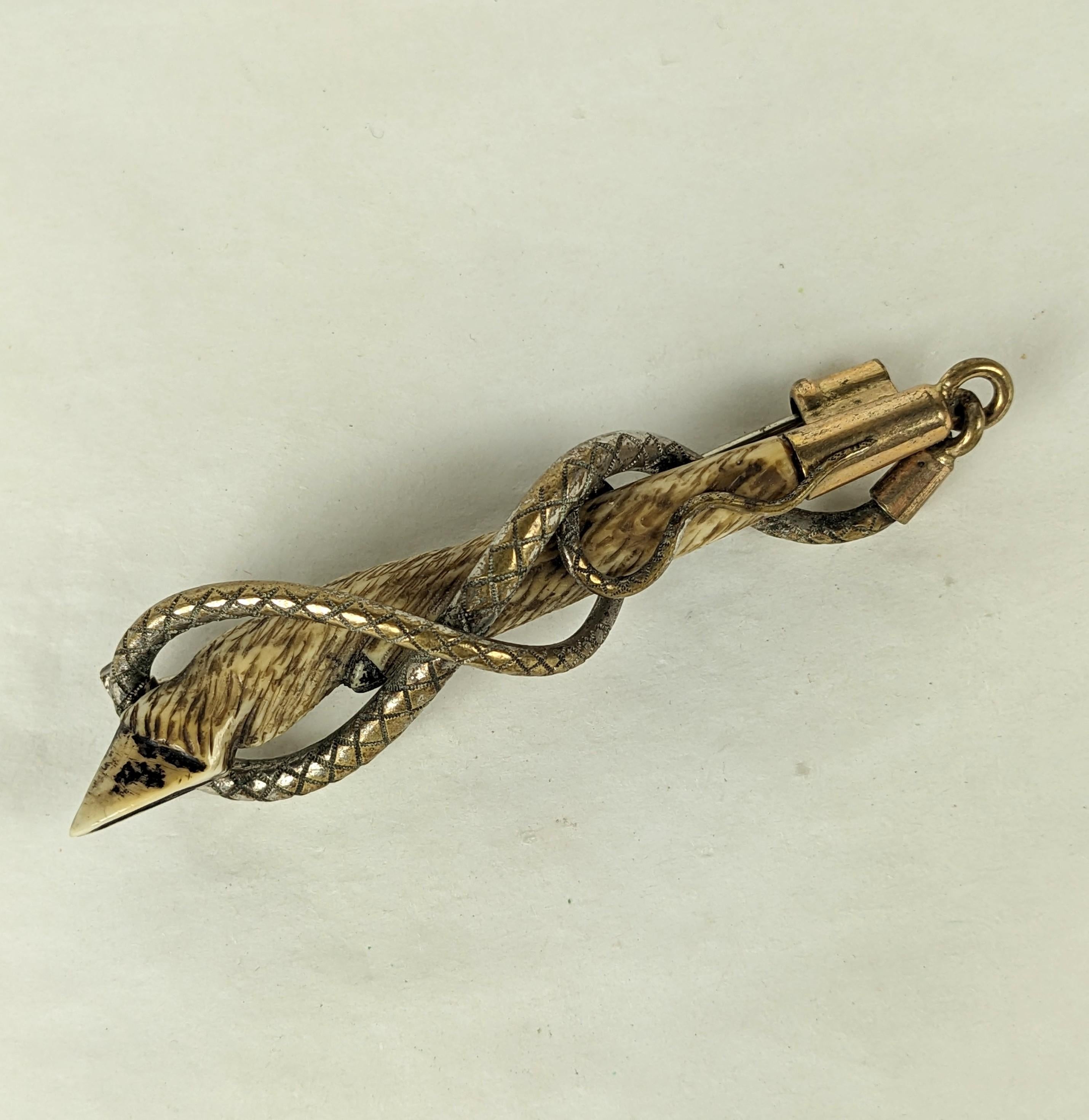 Unusual and Elegant Victorian Carved Bone Riding or Hunting Brooch from the 19th Century. A hand carved hoof is entwined by a textured snake like crop motif with gilt tips. 1870's. 3