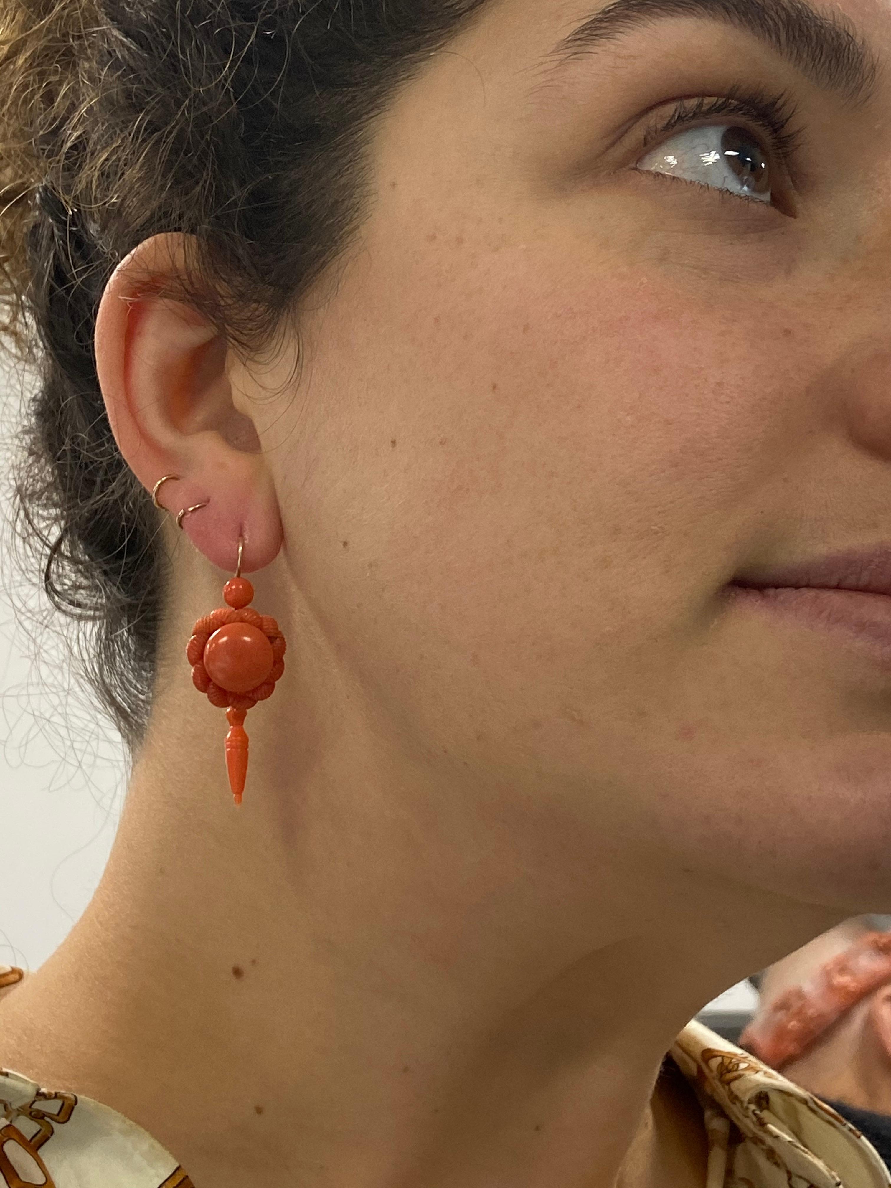A perfect pop of color, these Victorian carved coral pendant drop earrings measure 2 inches by 11/16 inches.  