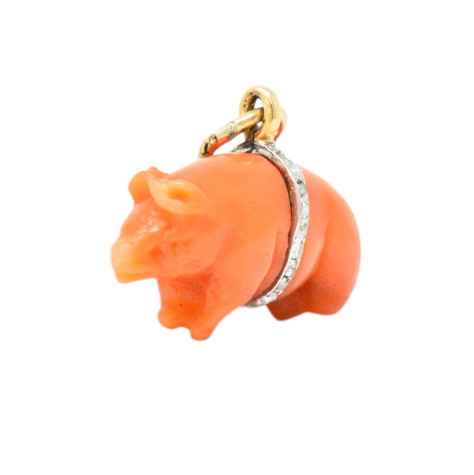 Charm is comprised of bright pinkish-orange coral

Intricately carved to depict a pig

Bisected by a gold band around its stomach, set fully around by rose cut diamonds (two missing)

Tested as 18 karat gold

Circa: 1905

Measures 12.0 mm x 10.0