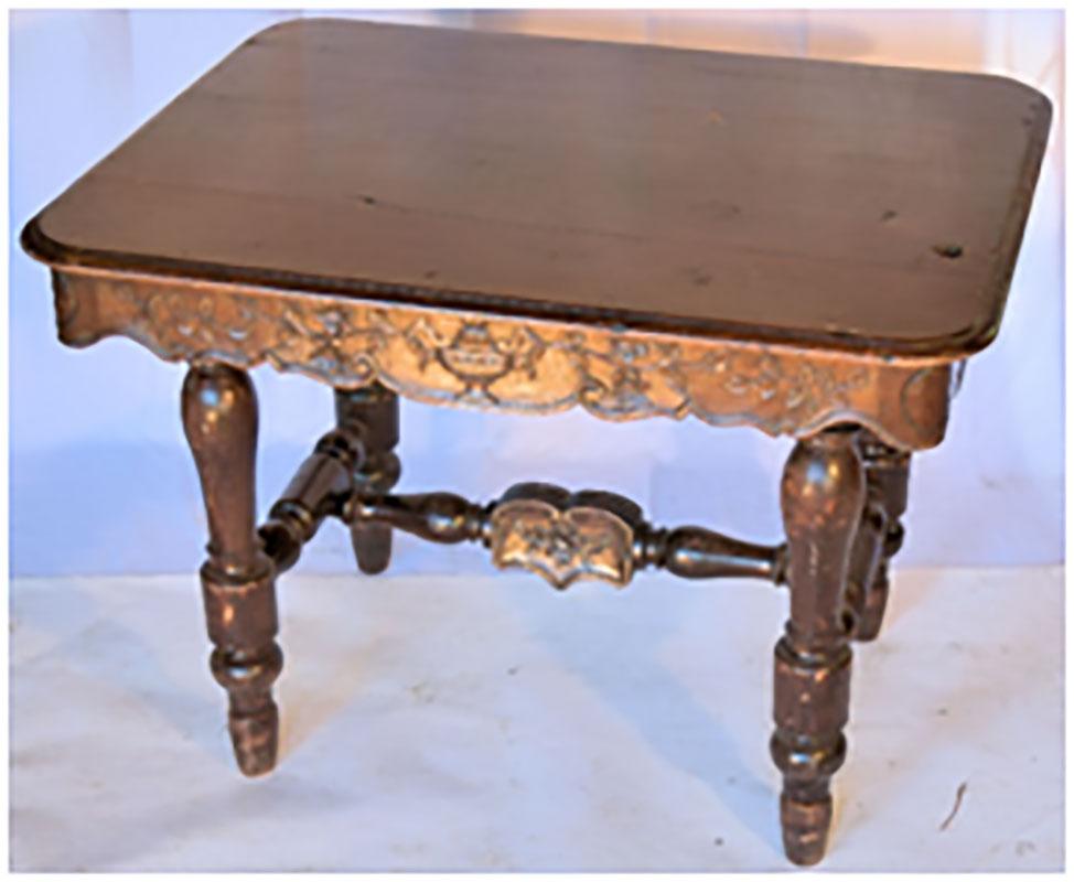 Victorian carved antique writing desk done in oak with tapered legs and hand carved floral/urn reliefs.

France, 1890.