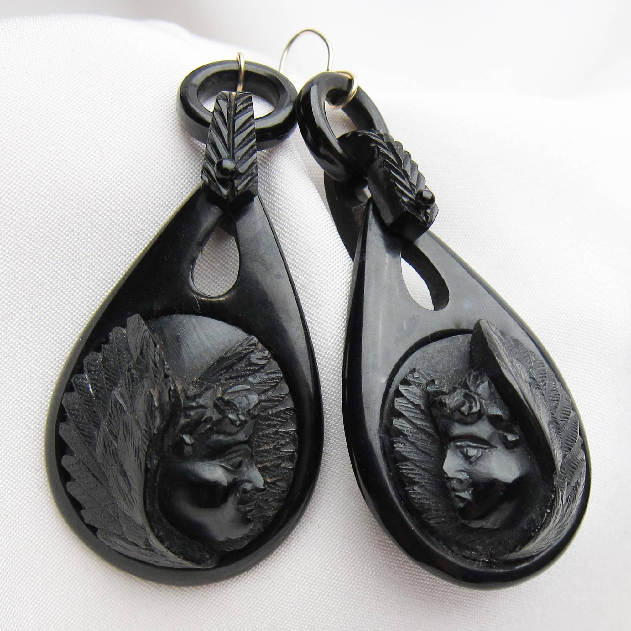 Each of these Victorian mourning earrings features a teardrop-shaped piece of gutta-percha carved with the face of a plump cherub. Black jewelry was popular in the late Victorian Era as Queen Victoria mourned the death of Price Albert, and her