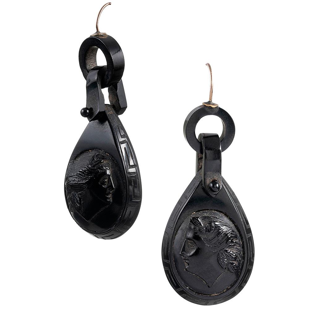 The classic Victorian buckle motif suspends a cameo profile of carved jet with a Greek-inspired pattern framing the border. Jet offers a dramatic look, but is very lightweight and easy to wear. These earrings measure approximately 2.25 inches long