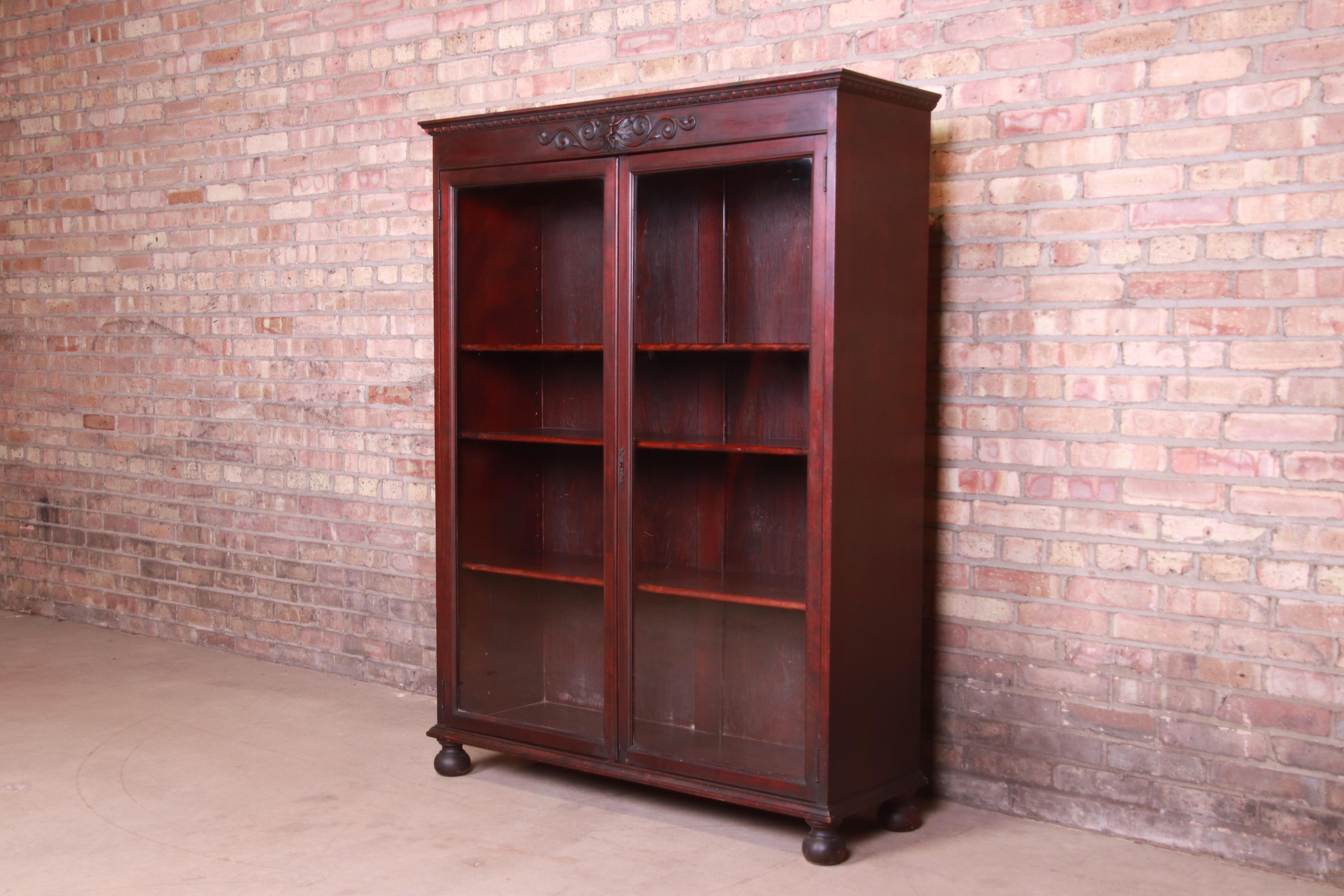 A gorgeous antique Victorian glass front bookcase with Old Man of the North carved face

USA, circa 1890

Carved mahogany, with glass front doors.

Measures: 44.88