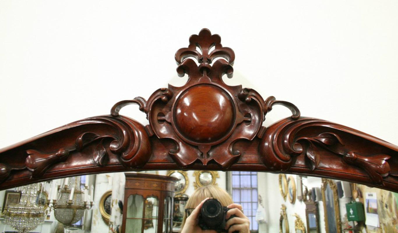 Magnificent Victorian carved mahogany mirror back hall/serving table in finest quality figured mahogany, with a shaped ornately carved mirror back with an open carved cartouche, all standing on bold cabriole legs with foliate carved knees, circa