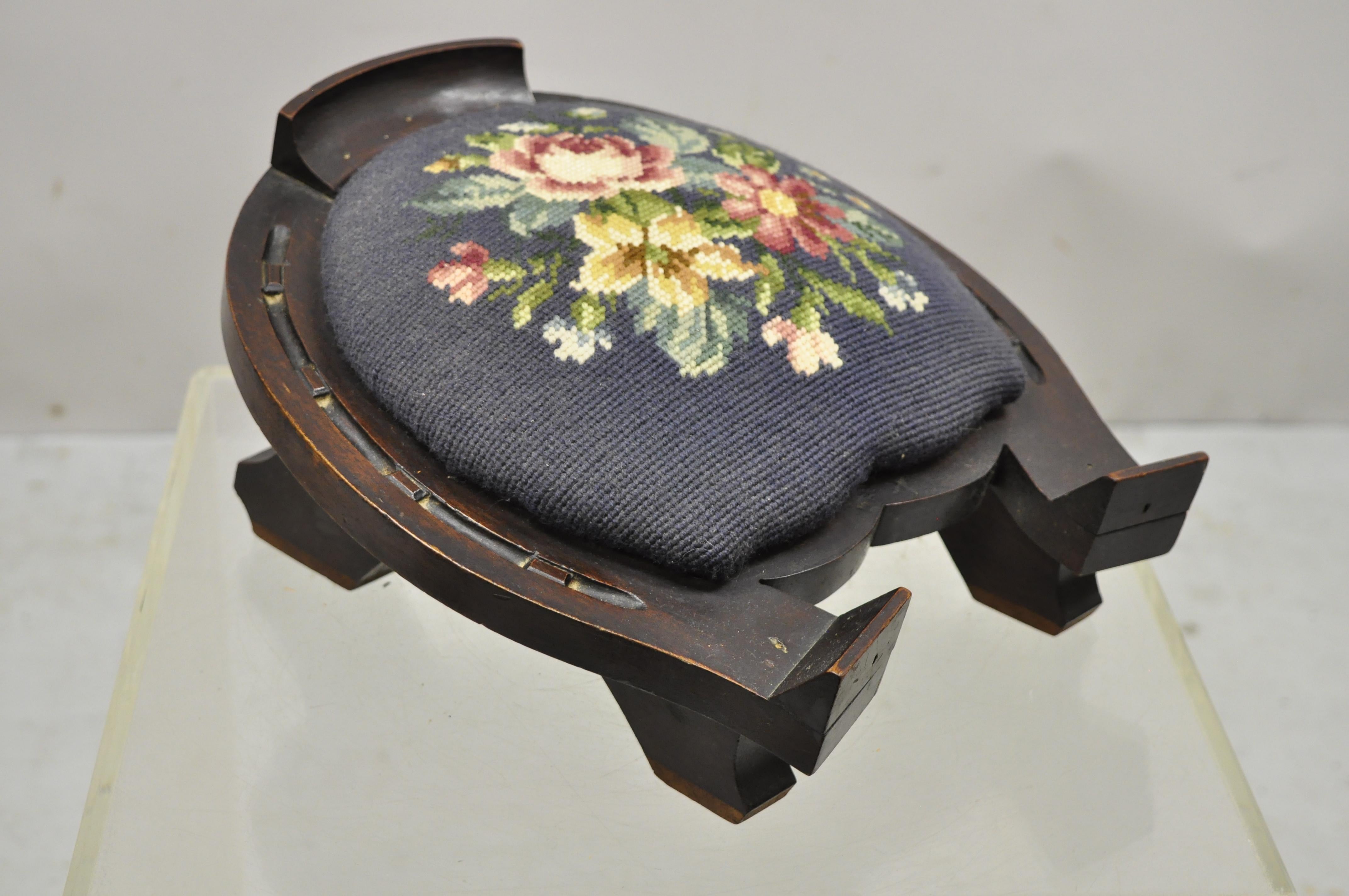 Victorian carved mahogany horseshoe needlepoint gout stool footstool ottoman. Item features floral needlepoint seat, solid wood frame, nicely carved details, very nice antique item. Circa 1900s. Measurements: 7