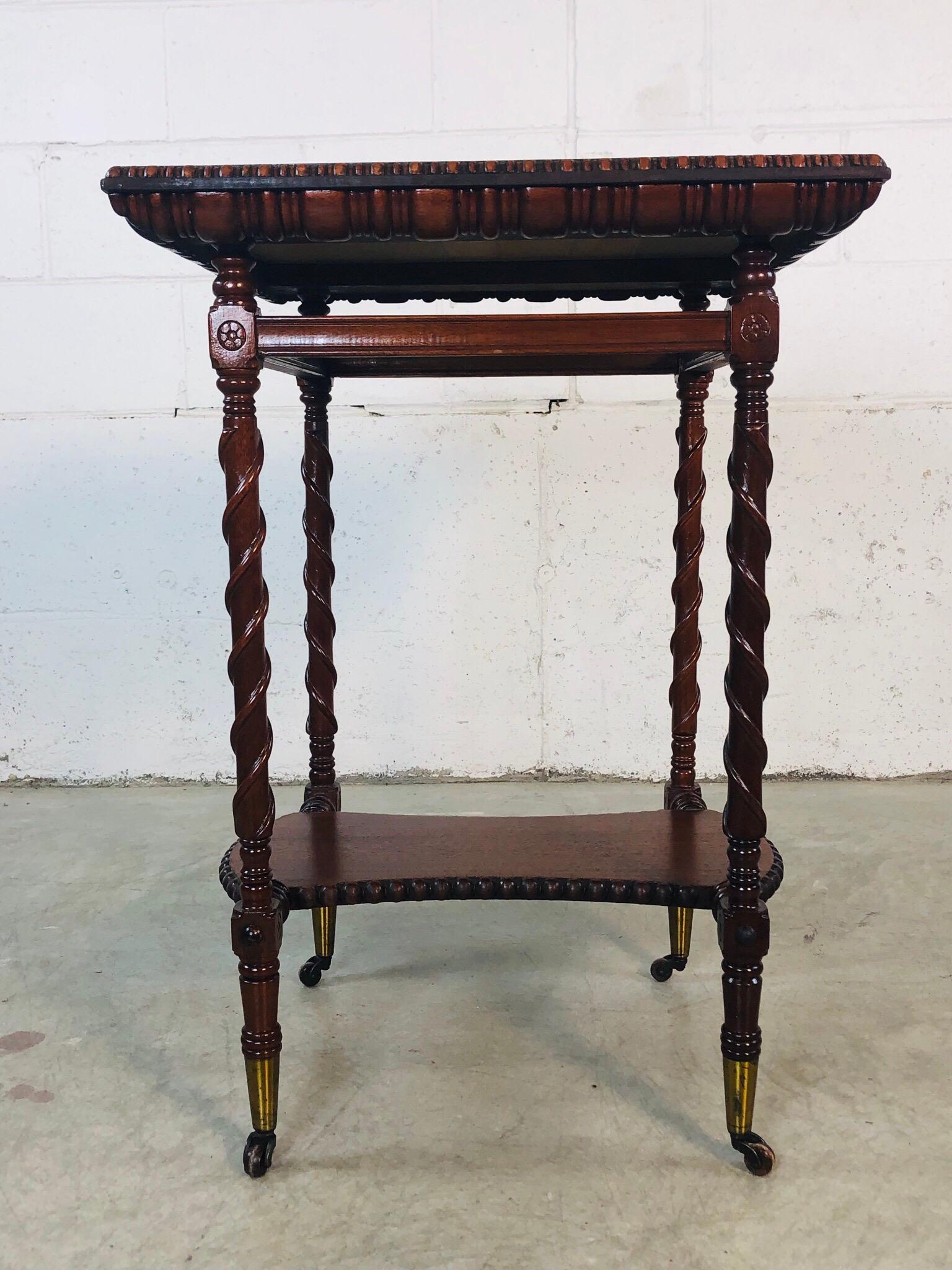 Victorian hand carved square mahogany side table with a rope carved accent. This Victorian table has beautiful hand carved sides and accents on all four sides. The table also has brass feet that roll. The second shelf also has carved balls along all