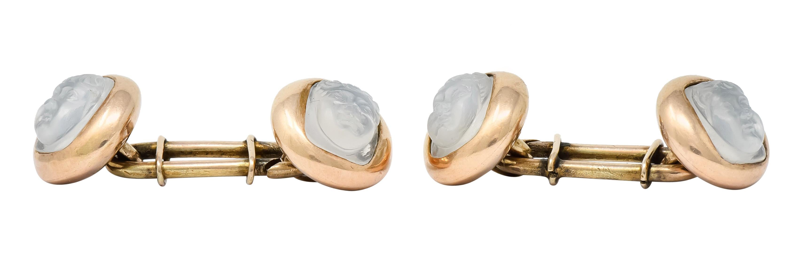 Link style cufflinks terminating on each end as a delicately carved moonstone to depict a highly rendered child's face

Moonstone is translucent with strong billowy white adularescence and is bezel set in a polished gold circular surround

Tested as