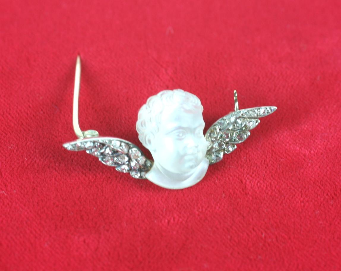 Wonderful and rare carved moonstone cherub brooch from the late Victorian era. Intricately carved moonstone putti head with incredible detail in the round. The carving alone on his locks of hair is extraordinary. 
Beautiful moonstone with wonderful