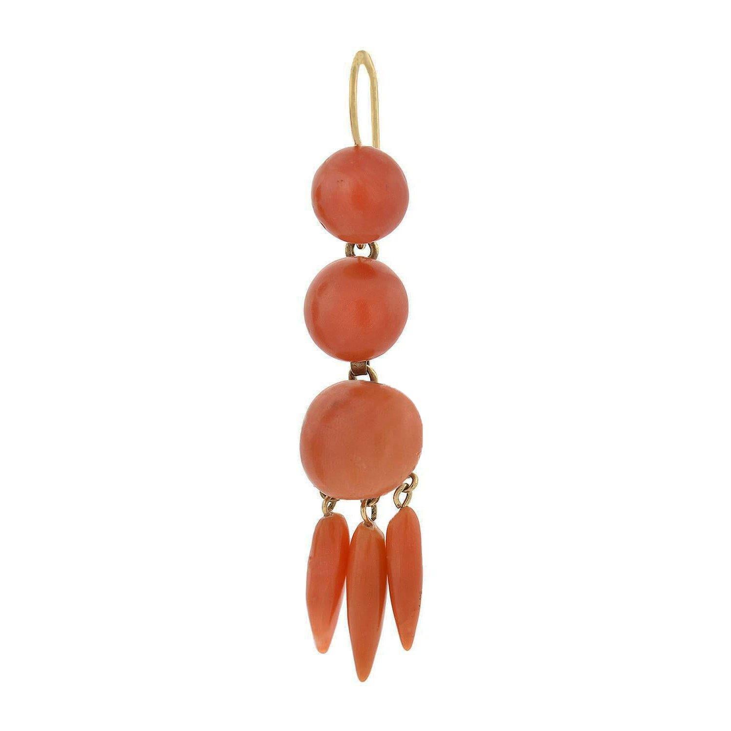 A wonderful pair of hanging coral earrings from the Victorian (ca1880s) era! Crafted in 14kt yellow gold these beautiful earrings feature smoothly-polished and hand-carved salmon-colored coral links. Each consists of three graduated coral beads