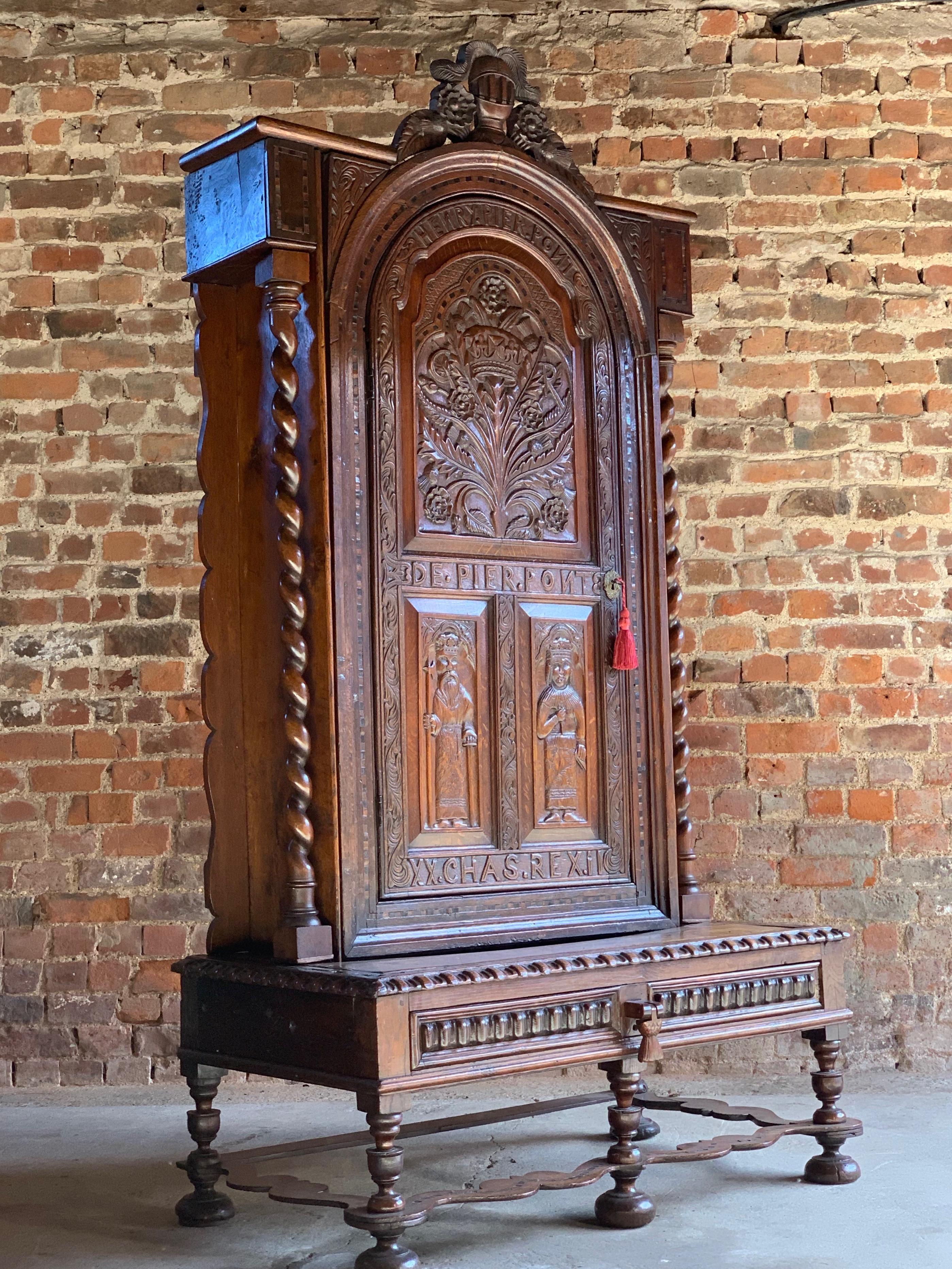 Victorian carved oak bookcase cabinet on stand 19th century Carolean style, 1850

A Victorian carved oak bookcase cabinet on stand circa 1850, 19th century, in Carolean style, surmounted by a carved knight's helm and plumes above rose, thistle and