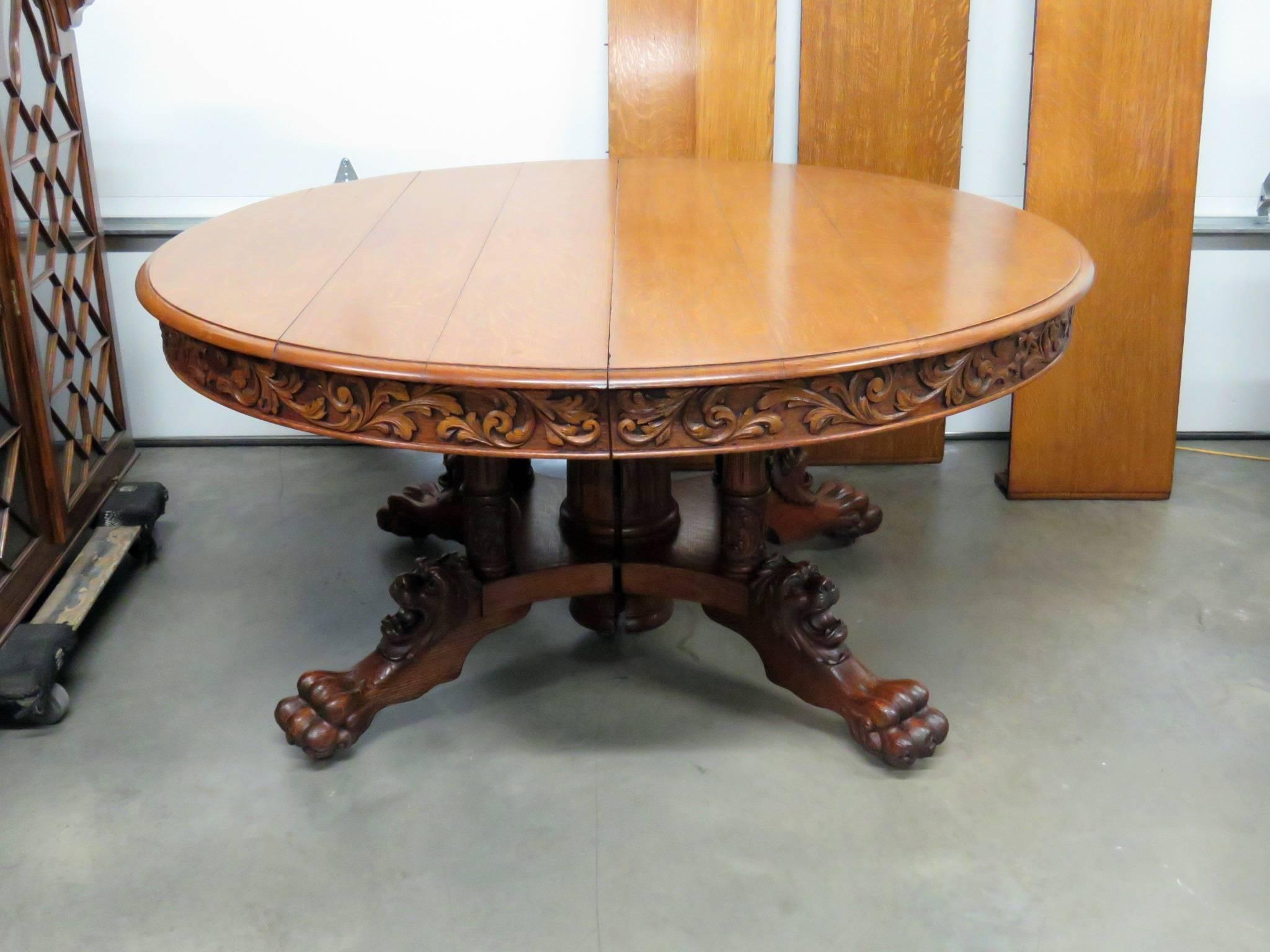 Victorian oak dining table with lion's heads, paw feet and 3 15
