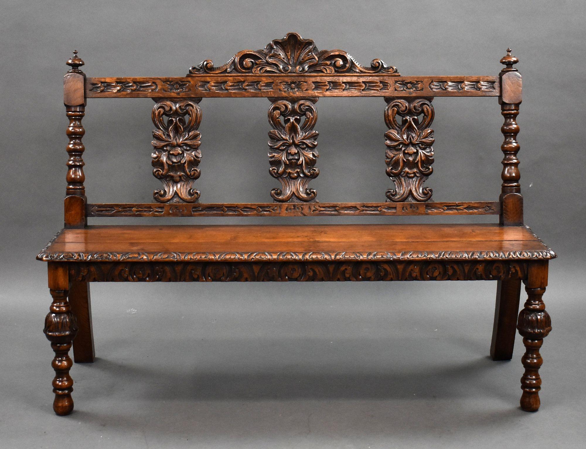For sale is a good quality Victorian carved oak hall bench, with a shell carved top rail and a carved green man motif to the carved back, with a solid seat raised on turned supports. This piece remains in very good condition for its age.

Width: