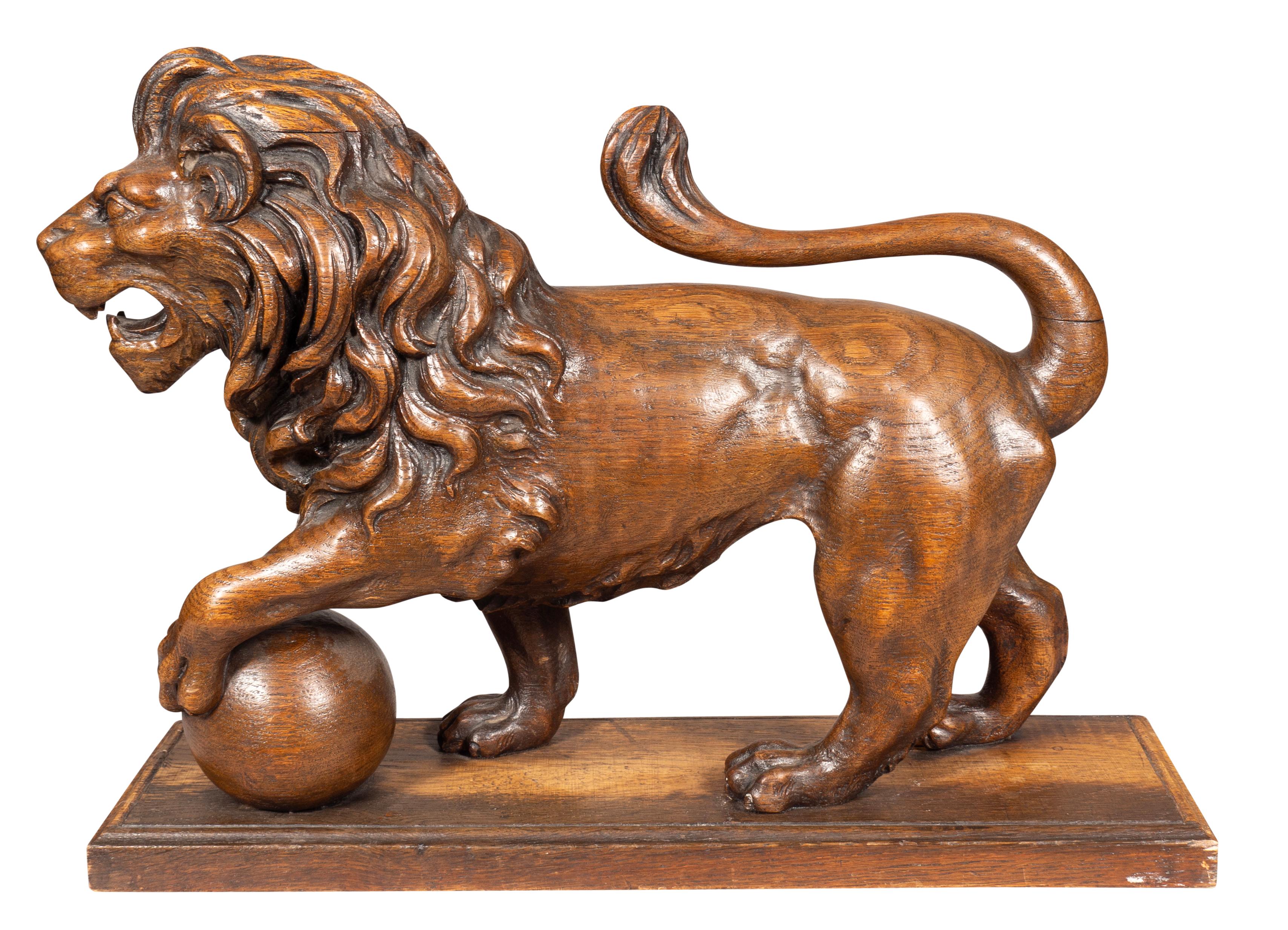 A well carved standing lion with front foot on an sphere. Rectangular base. Amherst Massachusetts estate.