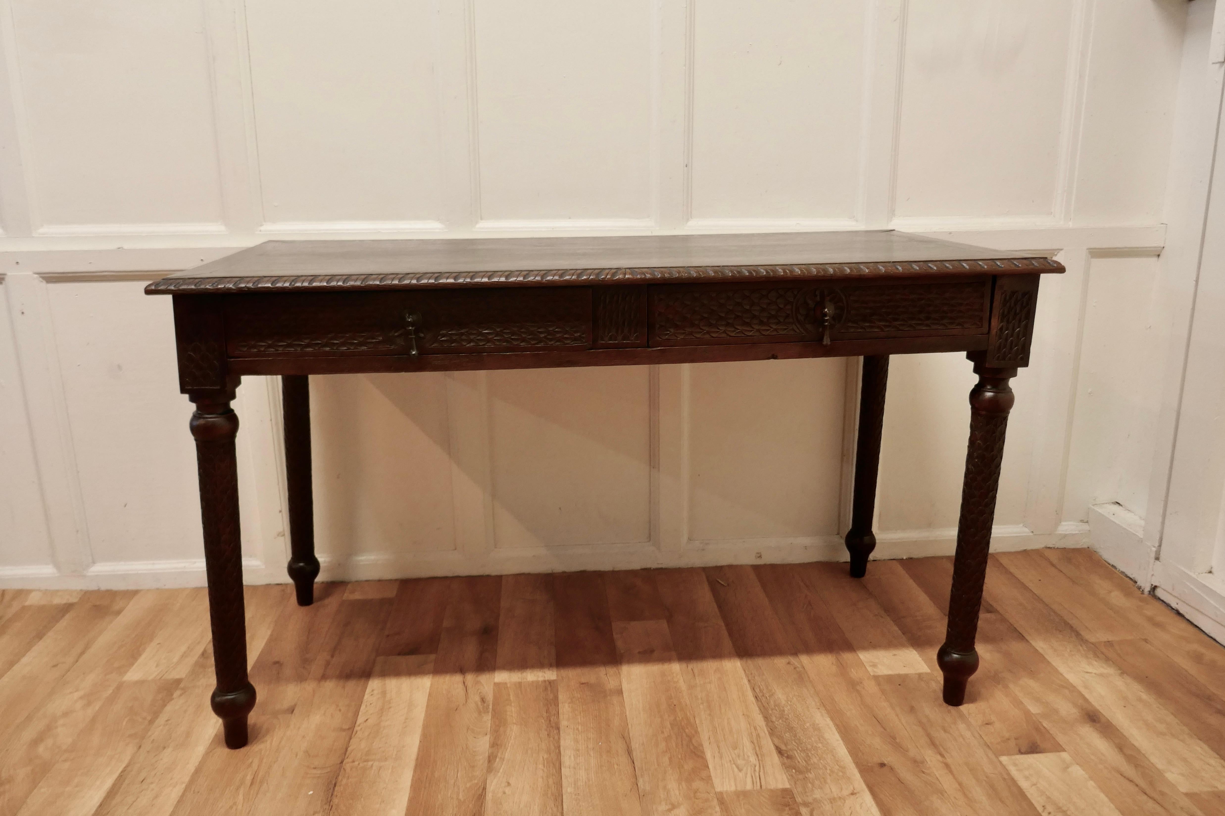 Victorian Carved Oak Writing Table
 
A particularly fine quality Writing table or desk the top has a rope carved top edge and a lattice style carved apron all round matching the decoration on the long elegant turned legs. 
The desk has 2 drawers