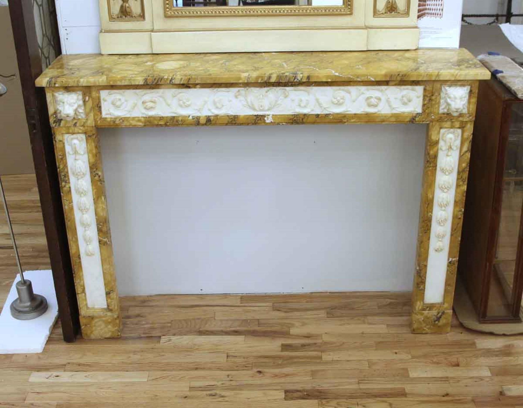 Early 20th century sienna marble Victorian mantel featuring white statuary inlaid panels. Hand carved highly detailed floral carvings. Each column top features highly carved lion heads. Matching sienna hearth not pictured. This can be seen at our