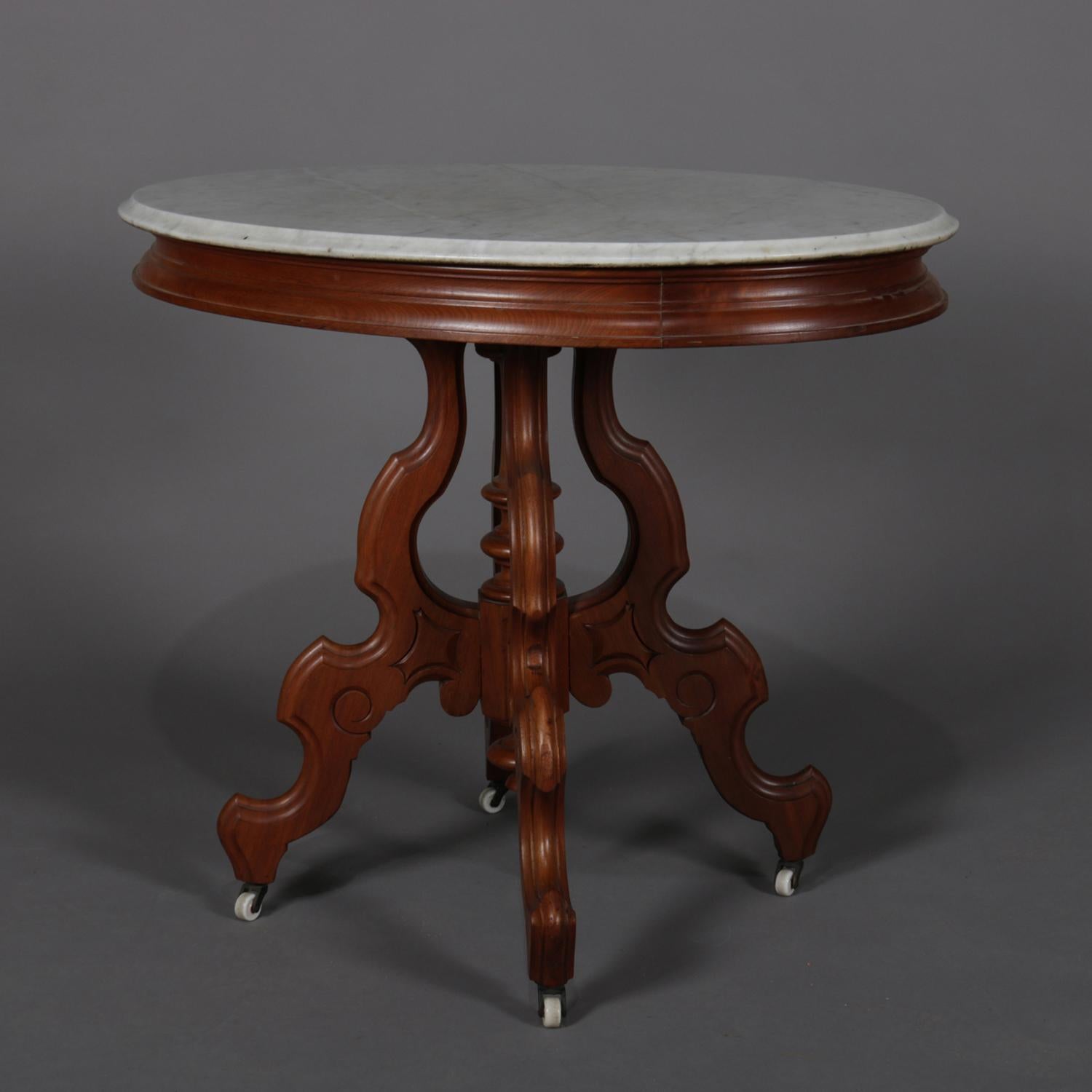 Antique Victorian centre table features oval form with beveled marble top surmounting carved walnut base with four legs and center turned column having drop finial, seated on casters, circa 1890

***DELIVERY NOTICE – Due to COVID-19 we are employing