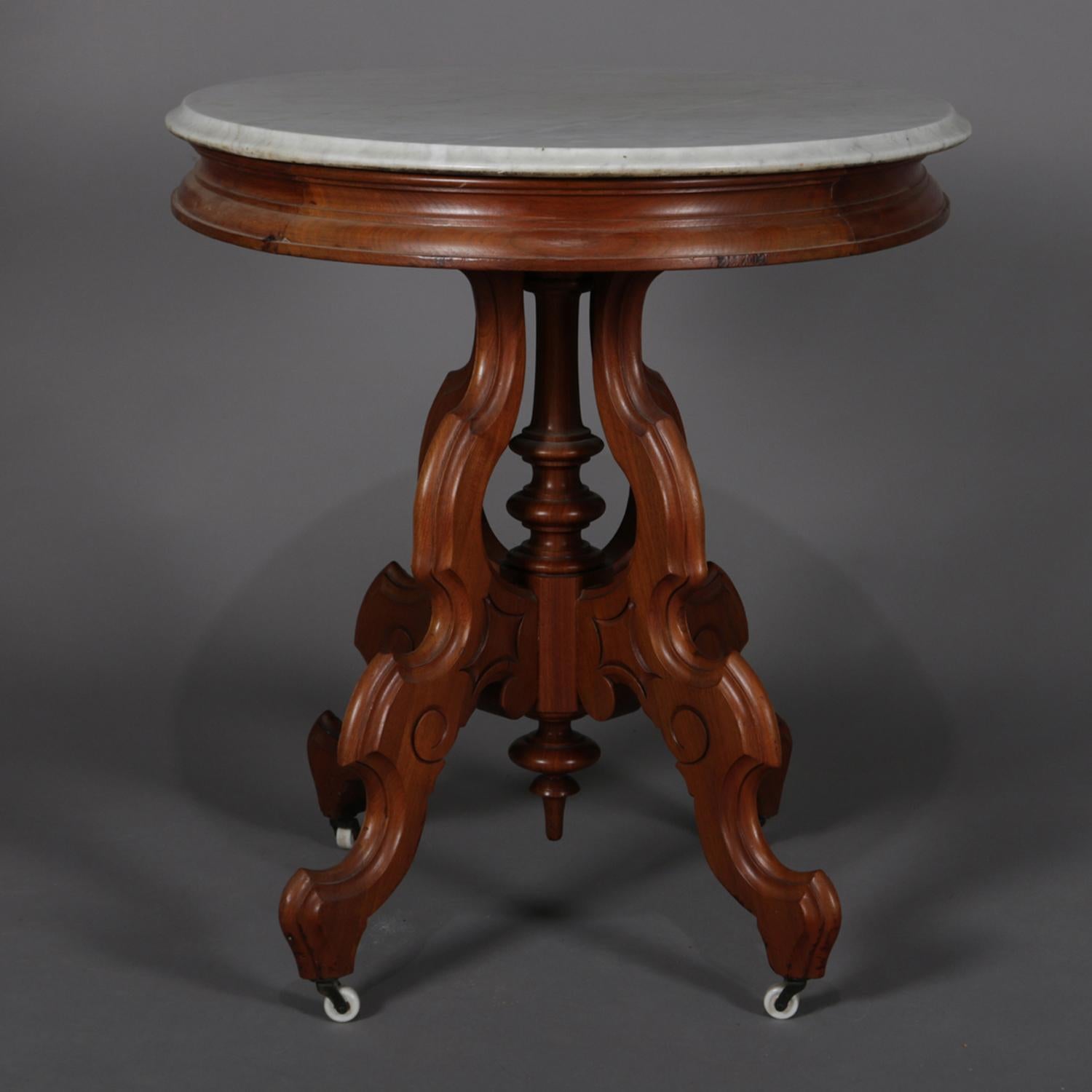 American Victorian Carved Walnut Marble-Top Oval Center Table, circa 1890