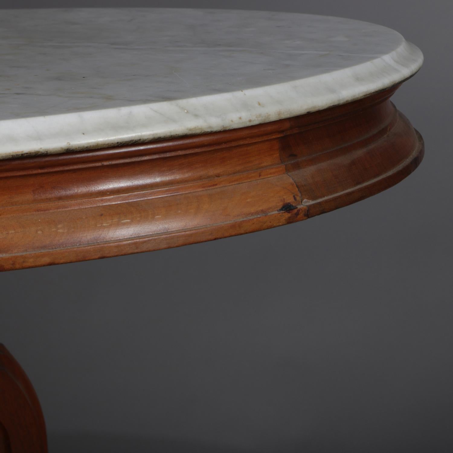 Beveled Victorian Carved Walnut Marble-Top Oval Center Table, circa 1890