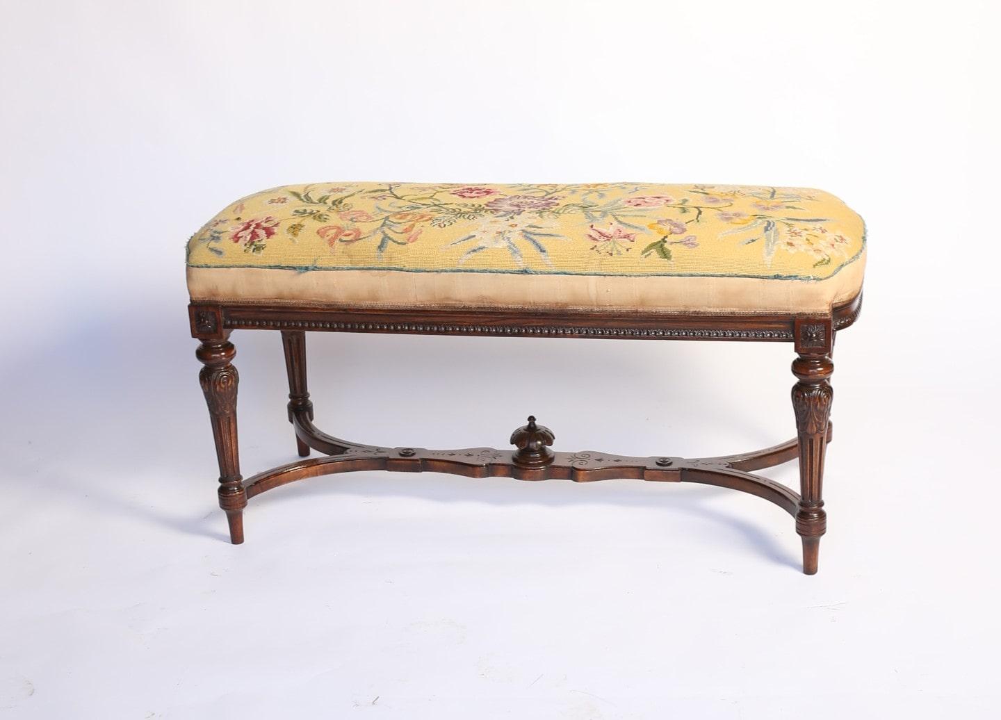 Late Victorian Carved Walnut duet stool / window seat, 
In the Hepplewhite manner, circa 1880s
Upholstered seat with needlepoint material, D shaped ends, 
Carved detail around frame, 
4 Carved & Fluted  tapering legs, with leaf carving