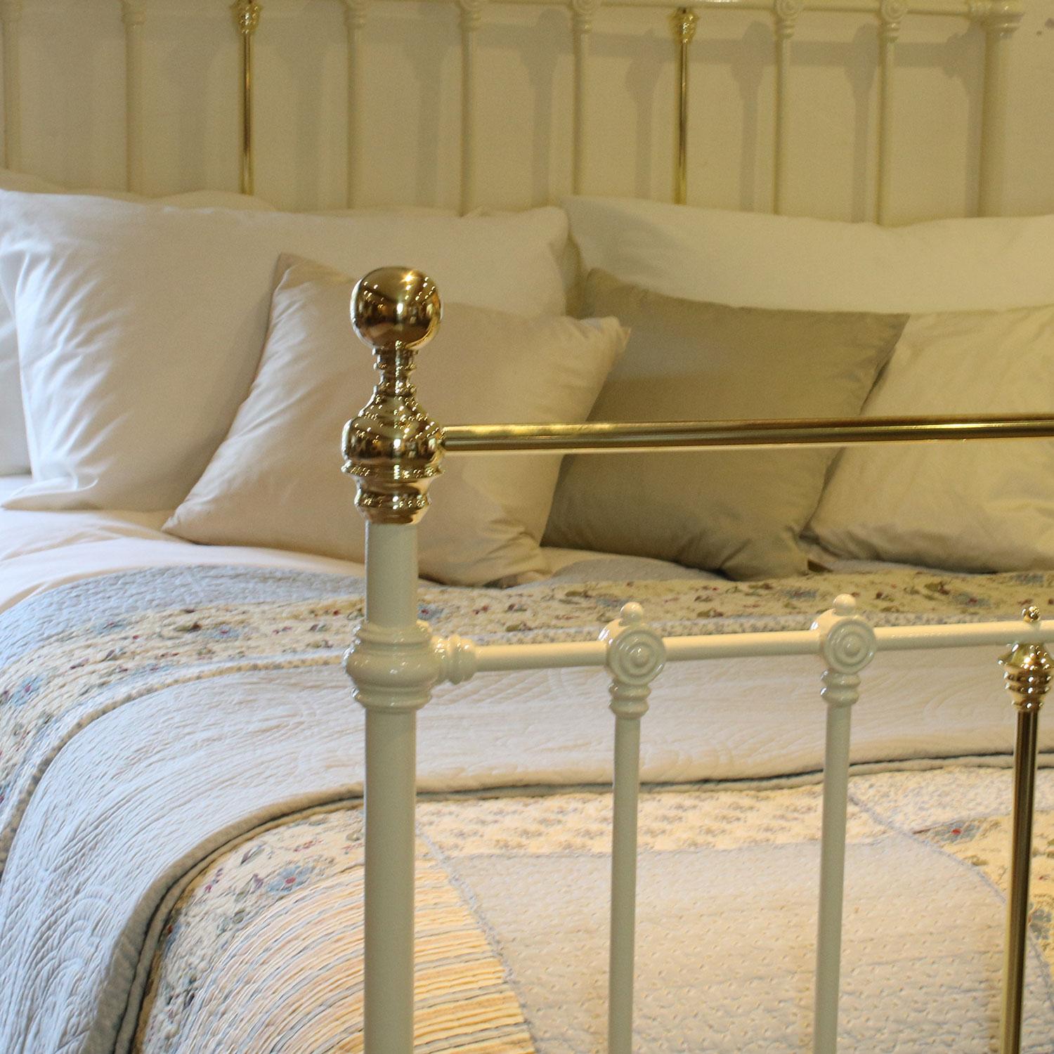 Victorian cast iron and brass bedstead finished in cream with straight brass top rails. This bed fits a 5'0