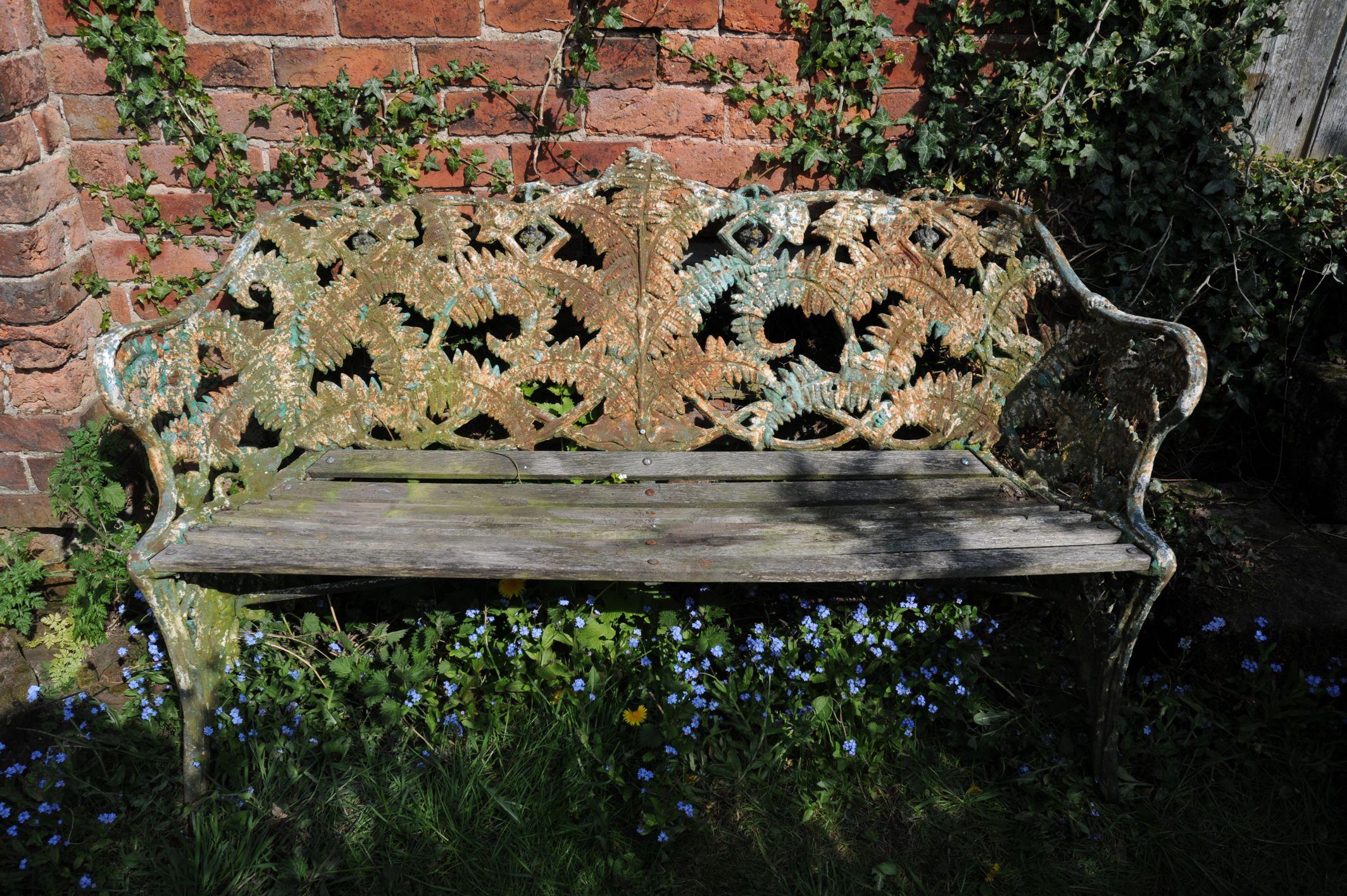 A wonderful Cast Iron and oak bench, Coalbrookdale Fern and Berry Pattern, several layers of lovely flaky paint and carefully replaced slats in weathered oak, ready to sit on!. We couldn't find a mark although there may be one, as found condition,