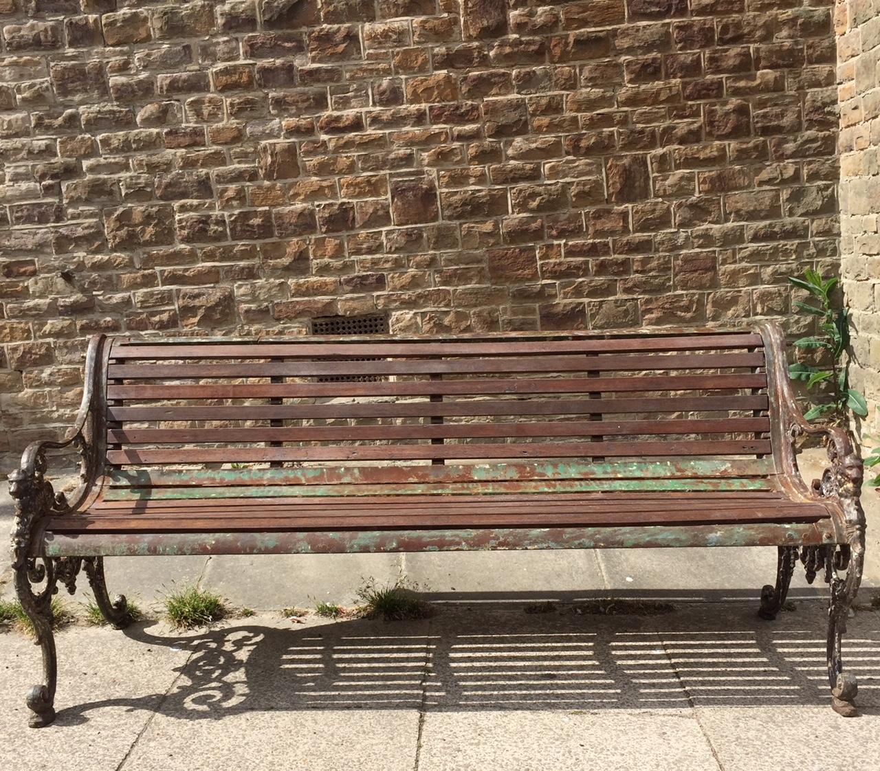 A delightful 19th century cast iron garden bench with the most beautiful look. The bench-end bracket supports of scrolling form with nicely detailed Lions Heads. We have replaced the slats on the bench but left the wonderful color and patina that so