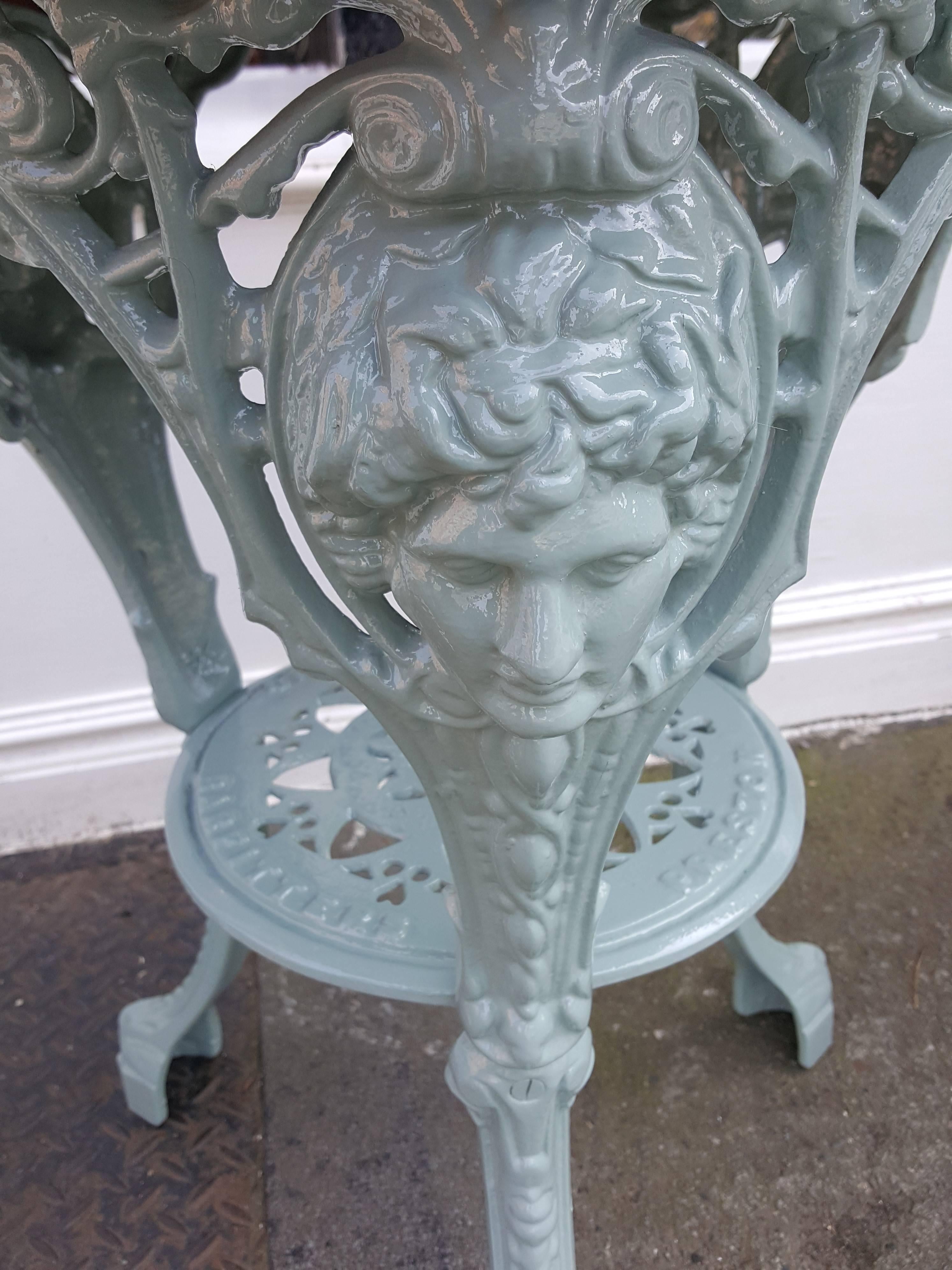 Victorian cast iron garden table with mahogany top decorated with Britannia cast portrait, hearts and lion paw feat - sold by Caskell and Chambers, Preston probably cast by Saxendale & Co Manchester.
Measures: 24