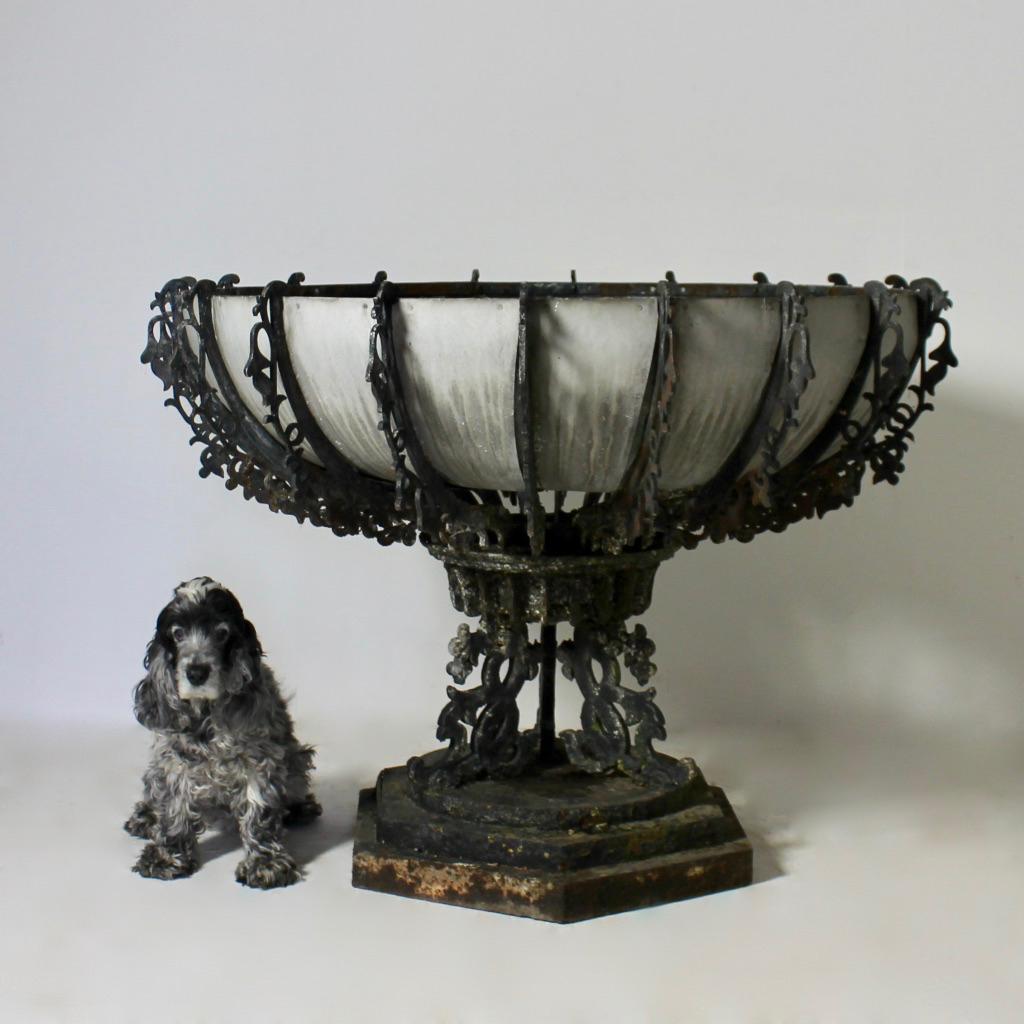 A Victorian, very large scale cast iron garden urn by Hunt and Pickering of Leicester. The fretted sectional bowl retaining its original zinc liner, the whole with many layers of ancient paint. In good order, two bowl sections with losses to the
