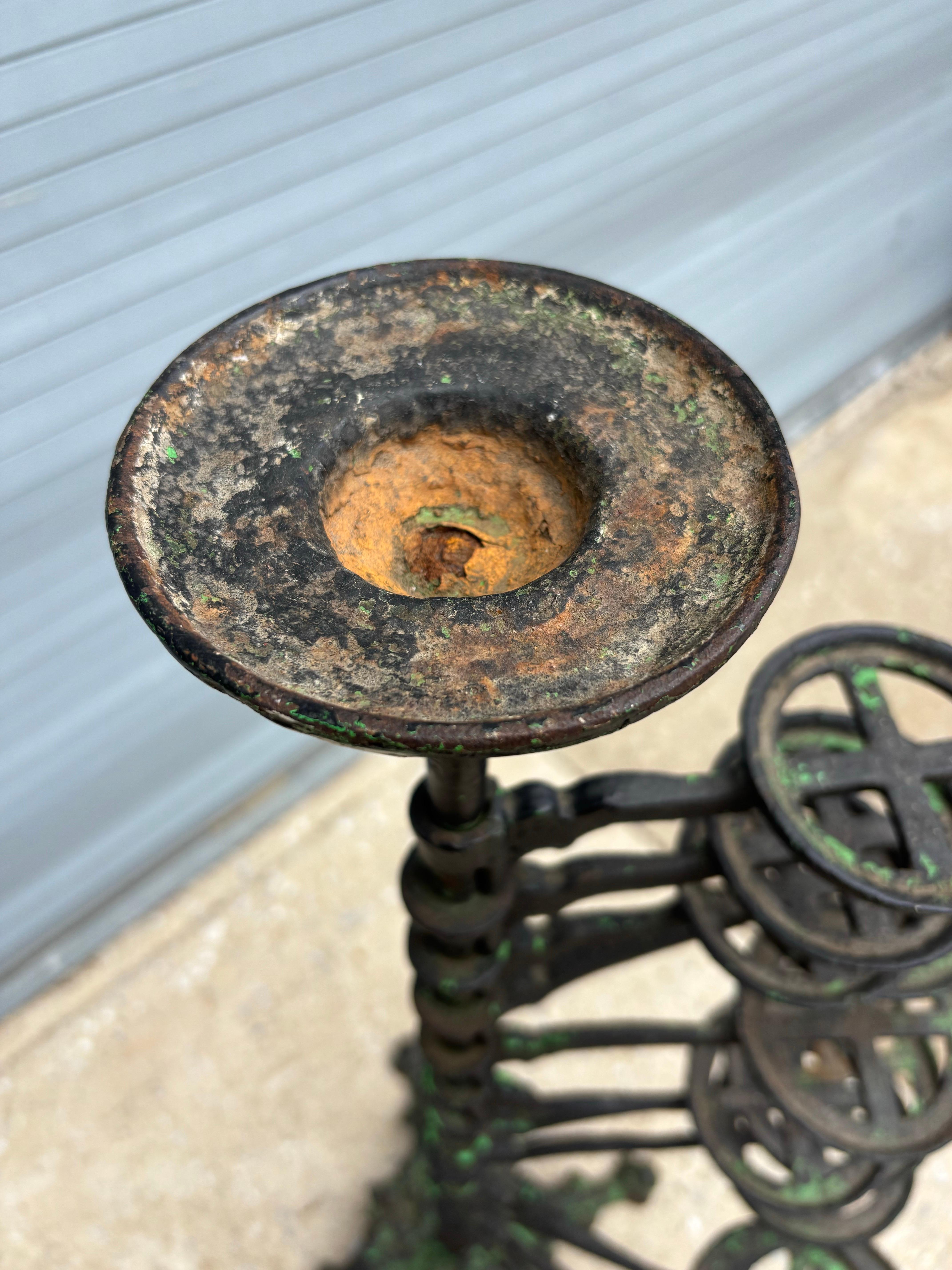 Large Heavy Rotating Iron Plant Stand.  Shows nice signs of use and wear with several layers of paint!  Rotates easily to place pots where you want them!  One arm is broken and missing, see photo!  Still looks amazing and perfect to stack a lot of