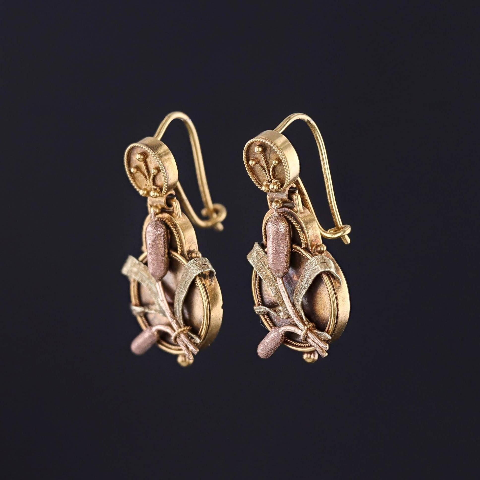 Antique Cattail Earrings: These 14k gold Victorian earrings (circa 1880-1900) are yellow gold and adorned with rose and green gold cattails.

Each earring measures 1.15 inches from the top of the ear wire to bottom by 0.6 inches wide. They are in