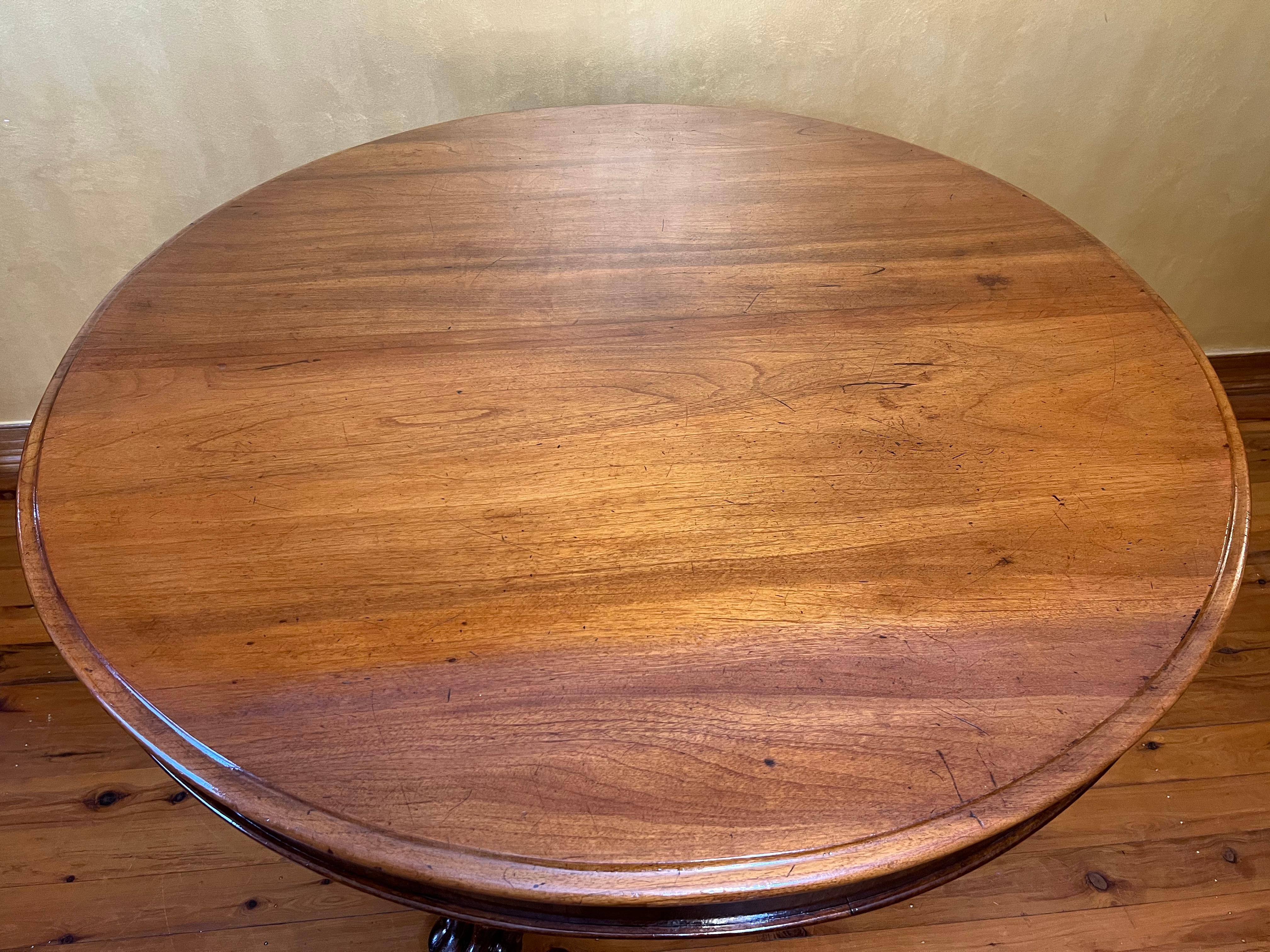 Tilt top design, top can come completely off for easy transport and moving, lion claw feet and grape carving on each legs, porcelain castors on each leg, there is scratch marks to the top due to age can be sanded and re polished if desired a more