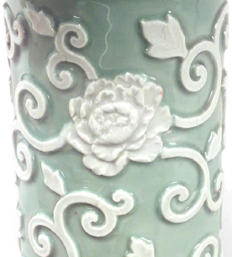 English Victorian-style (19/20th century) celadon and white porcelain umbrella stand with circular shape and floral relief.