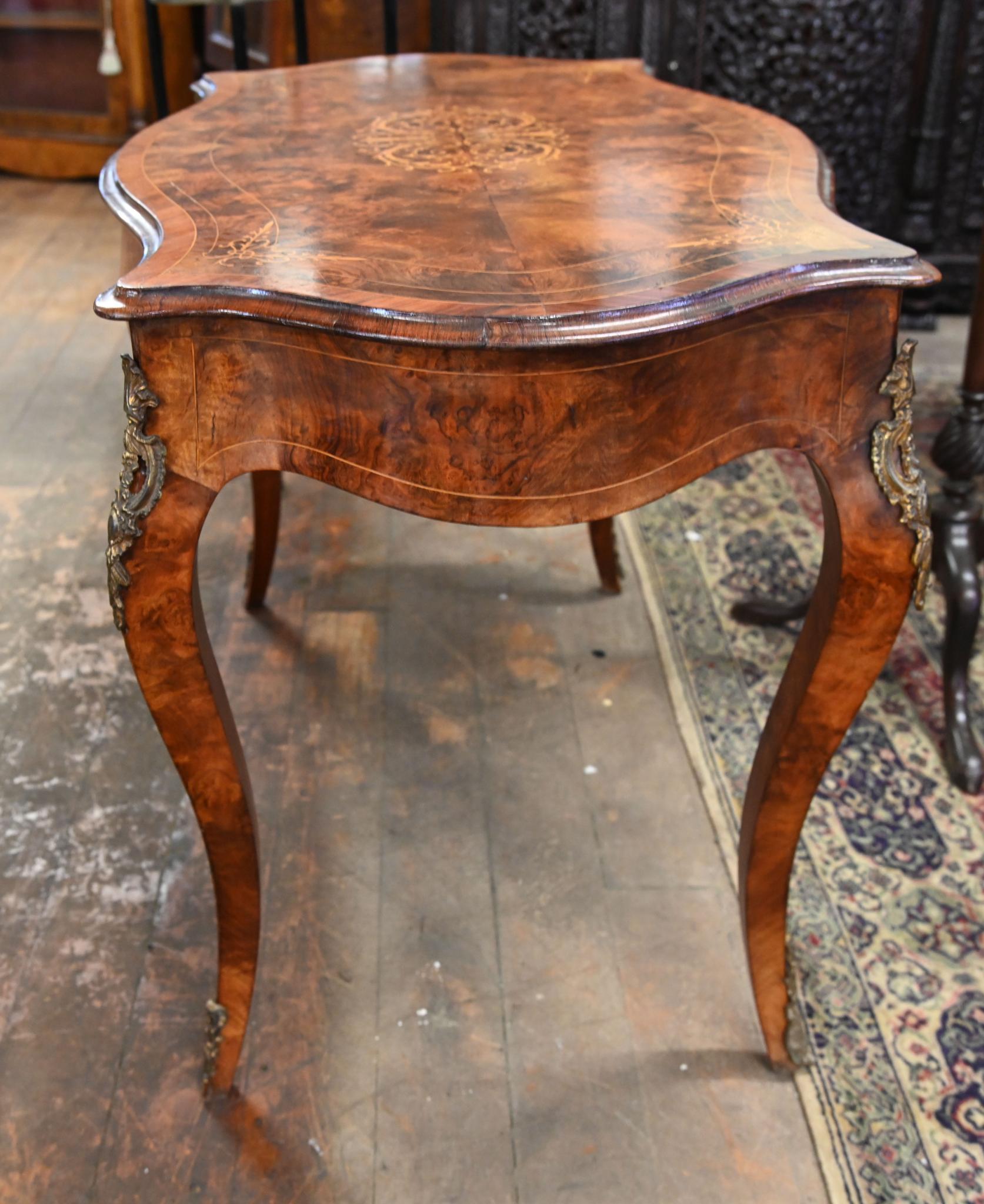 Victorian walnut and marquetry inlay centre table with ormulo mounts
Circa 1860
Lovely shaped top with curves that are ergonomic and comfortable to sit at
Inlay designs include floral motifs
Bought from a private house sale in London's Belgravia
We