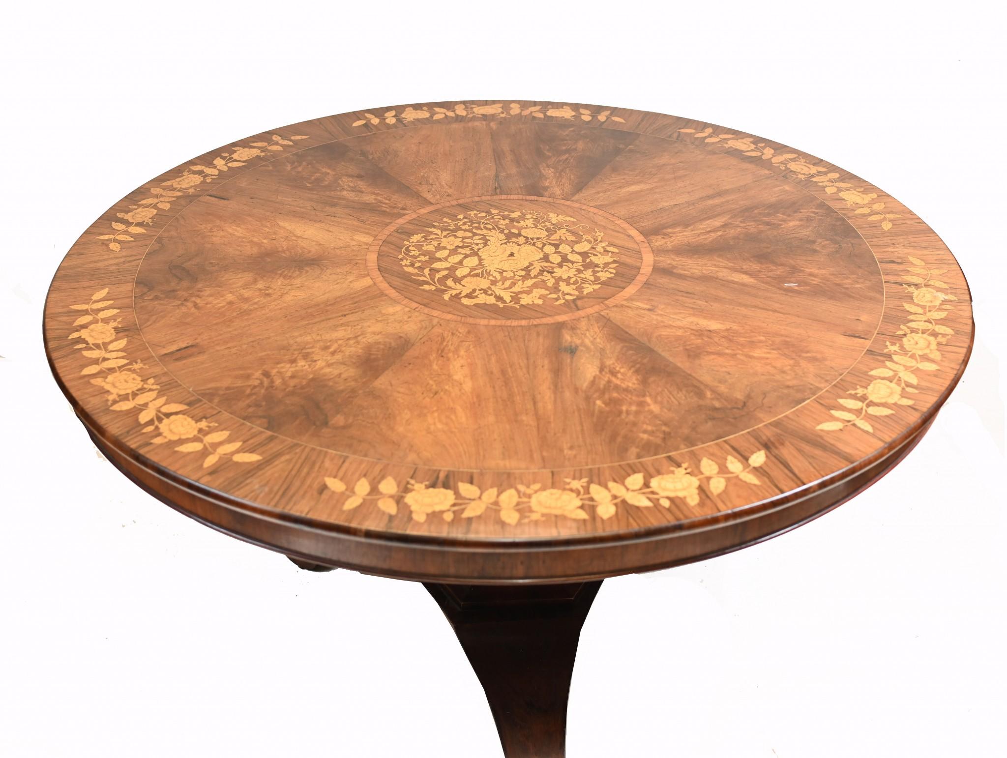 Elegant Victorian round centre table that can also be used for dining
Walnut with rosewood crossbanding decorated with marquetry flower patterns 
Circa 1830
Offered in great shape ready for home use right away
We ship to every corner of the