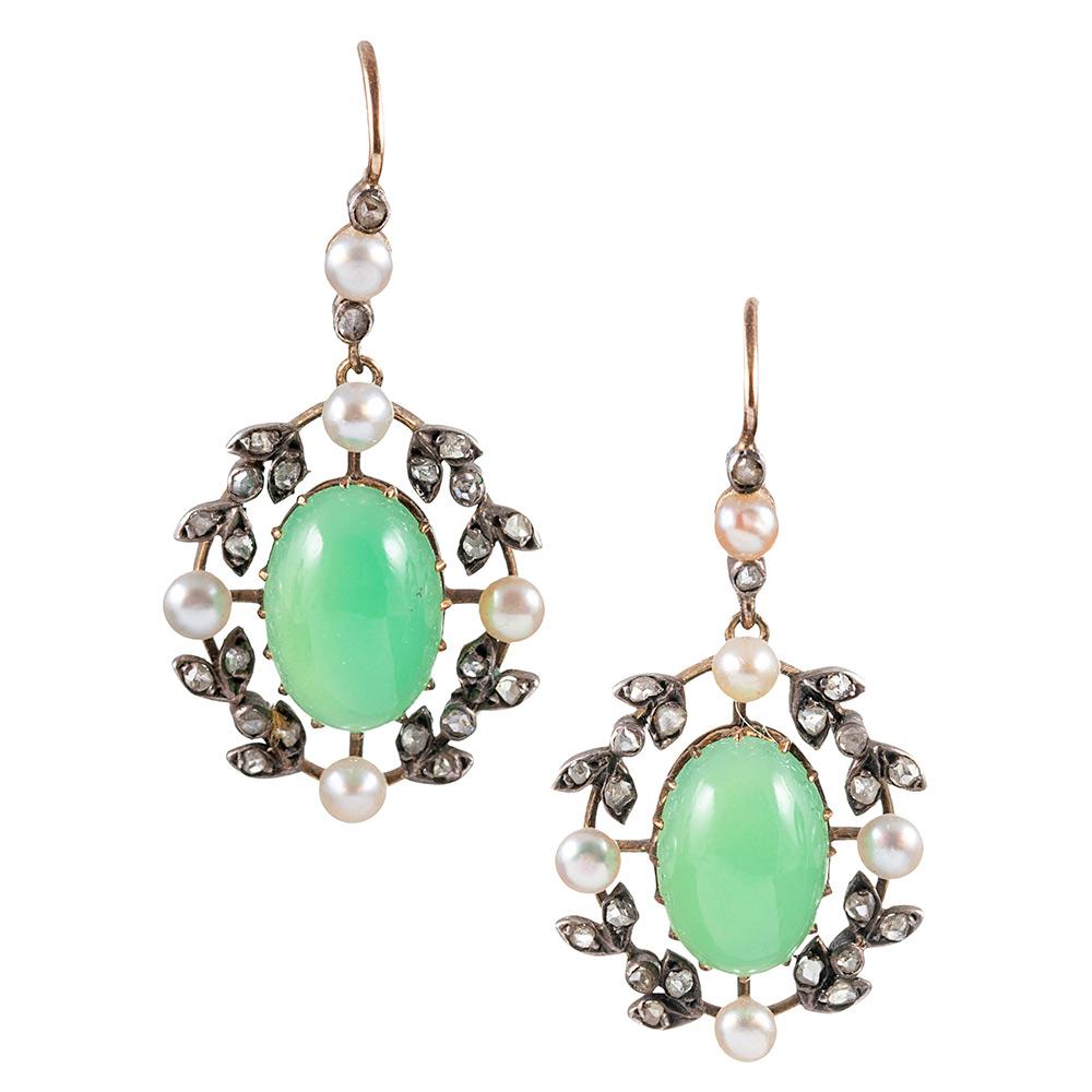 A Victorian rendering of became Edwardian style, the earrings and pendant are rendered in silver over yellow gold and set with cabochons of chrysoprase, lustrous seed pearls and rose cut diamonds. As is traditional for Victorian jewels, the pendant