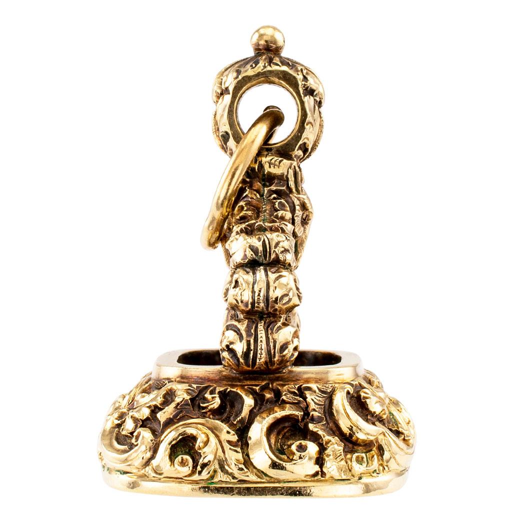 Victorian chalcedony intaglio gold fob circa 1870. Crafted in 14-karat yellow gold, featuring on two sides the head of a fox surrounded by an abundance of scrolling motifs and acanthus leaves, to the bottom surface encompassing a bezel-set,