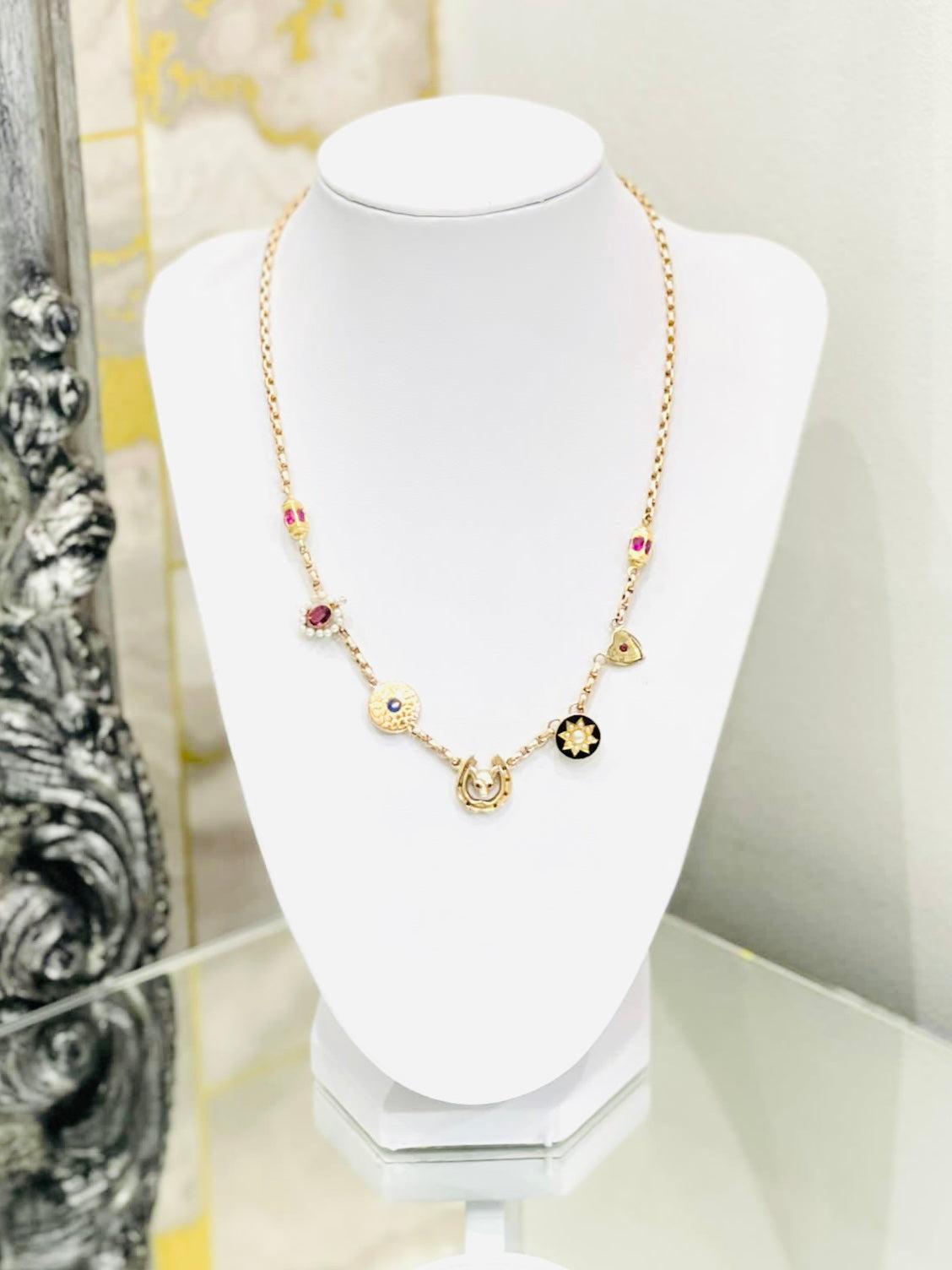 Victorian Charm Necklace 15ct Gold With Rubies, Sapphires & Pearls

Fixed multiple charms sat on a hoop link necklace. Charms having old hallmarks in a mix of 15ct,  9ct gold and luxury gemstones:
- Fox with Ruby eyes in a horse shoe also set with