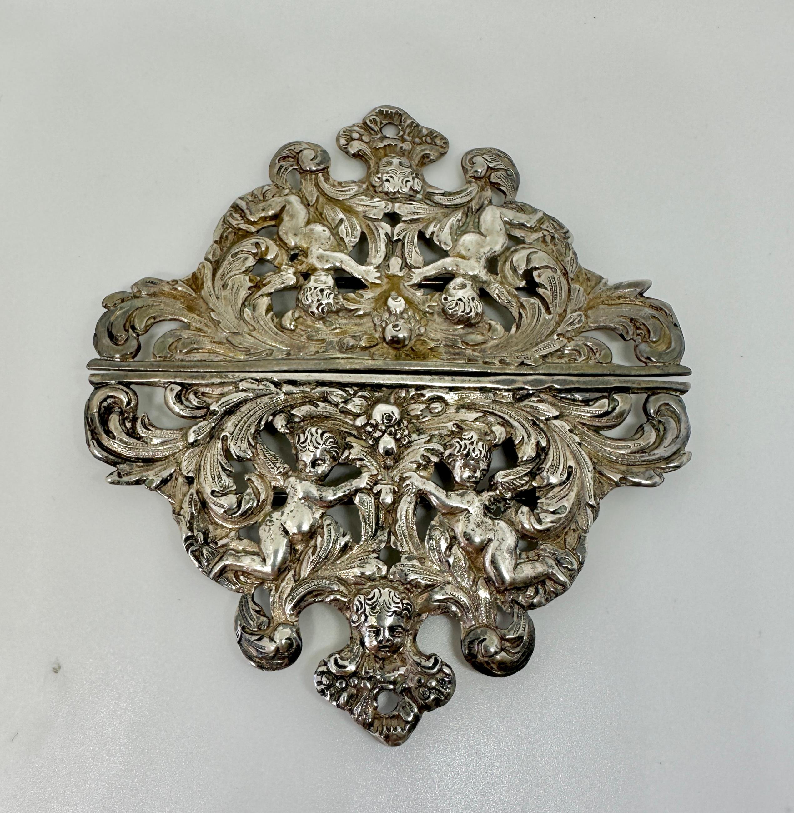 This is a stunning and rare large 4.5 inch antique Victorian Belle Epoque Belt Buckle in Sterling Silver with Cherub and Angel Imagery with acanthus leaf and fruit designs throughout.  The buckle is beautifully made with heavy Sterling Silver.  The