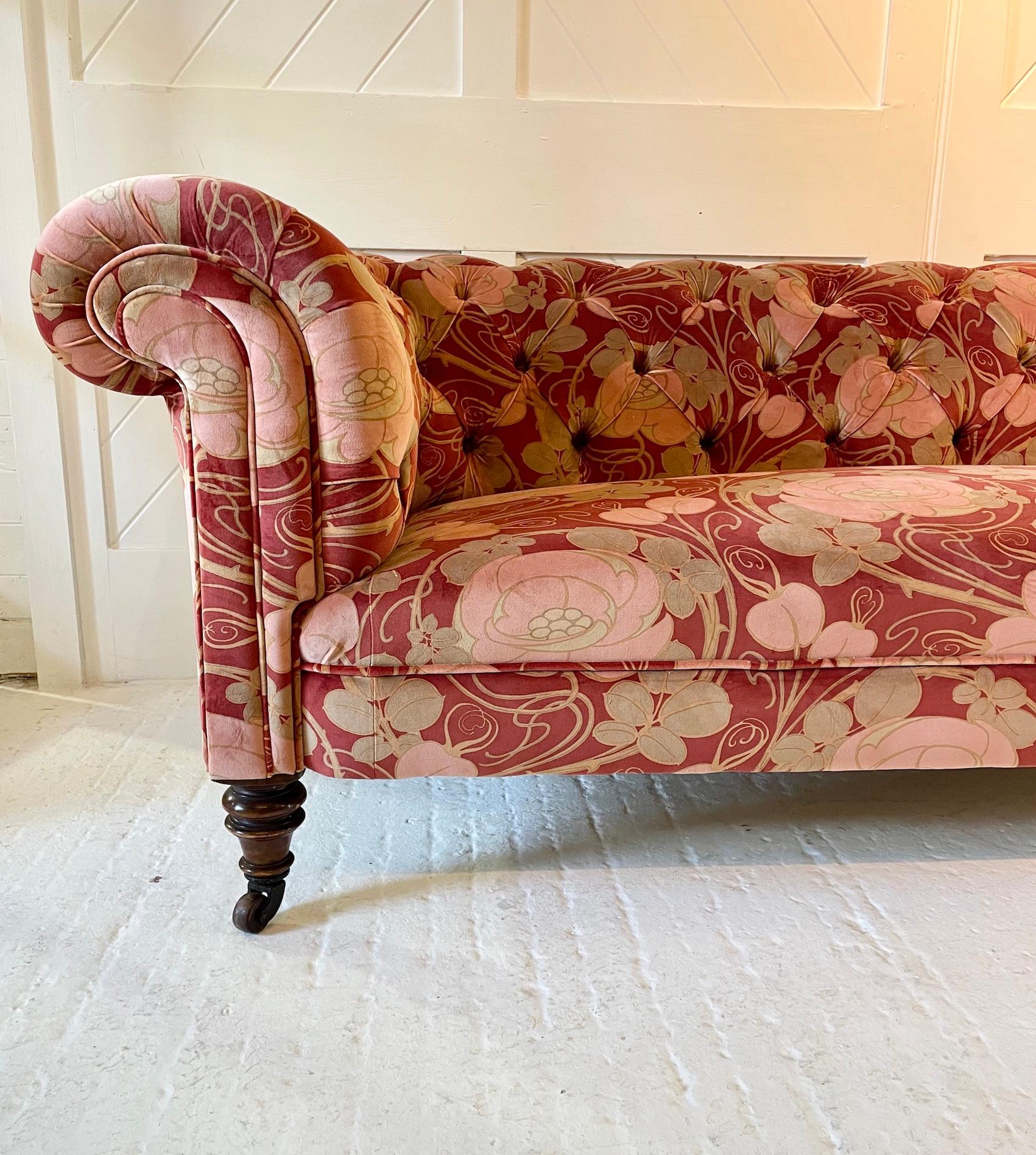 Victorian Chesterfield button-back settee
Traditionally re-upholstered 
Raised with lignum vitae and cast-iron castors
Circa 1890
Covered in ‘Glasgow Rose’ cotton velvet ‘Claret’
Fabric by Patch Rogers Design
Rosebank Fabrics

Patch is proud