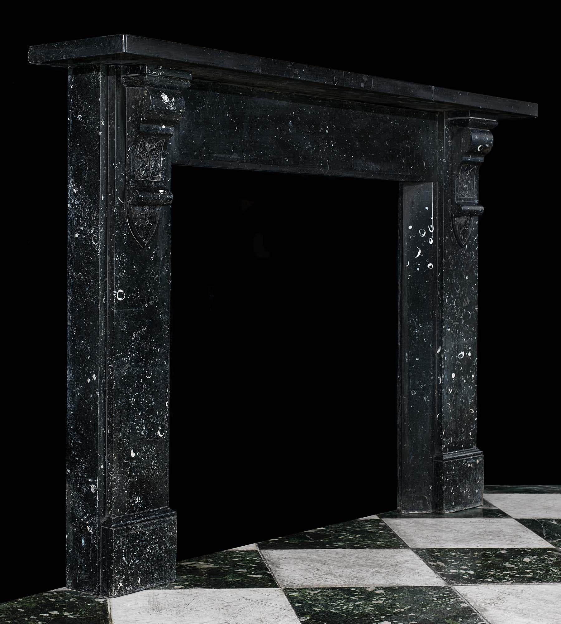 A large and elegant Victorian fireplace surround in Black Kilkenny Fossil Marble the large corbels, which support the wide moulded shelf, are incised with ivy leaf decoration. Scottish, circa 1870.