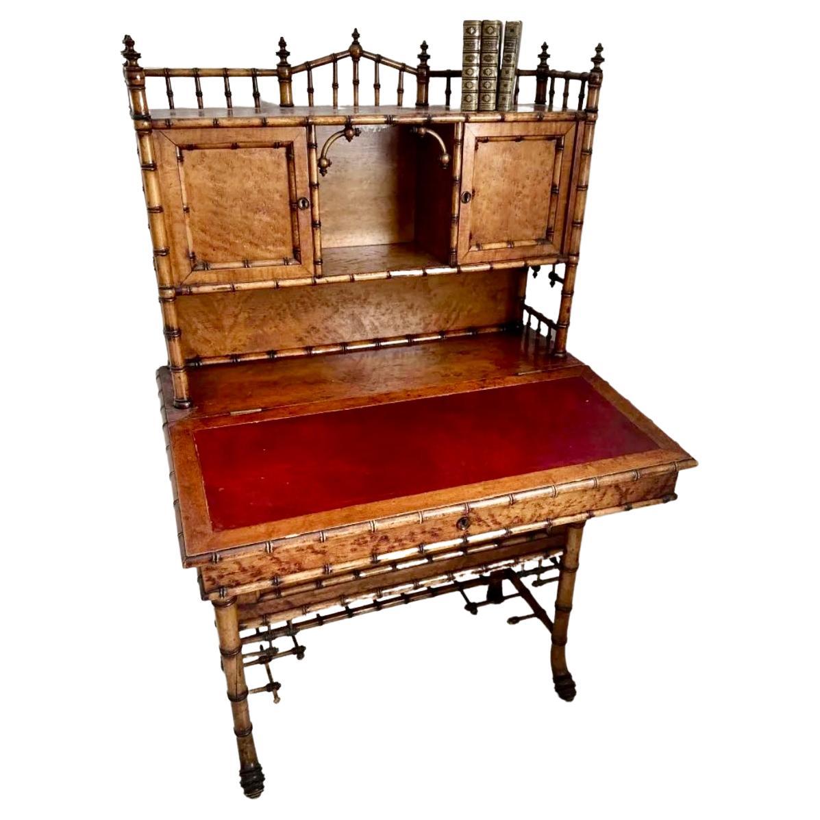 19th century Victorian Faux Bamboo Aesthetic Movement desk attributed to  R.J. Horner. In two sections, the upper recessed section with a three-quarter gallery above closed and open compartments, the lower section with a slightly canted overhanging