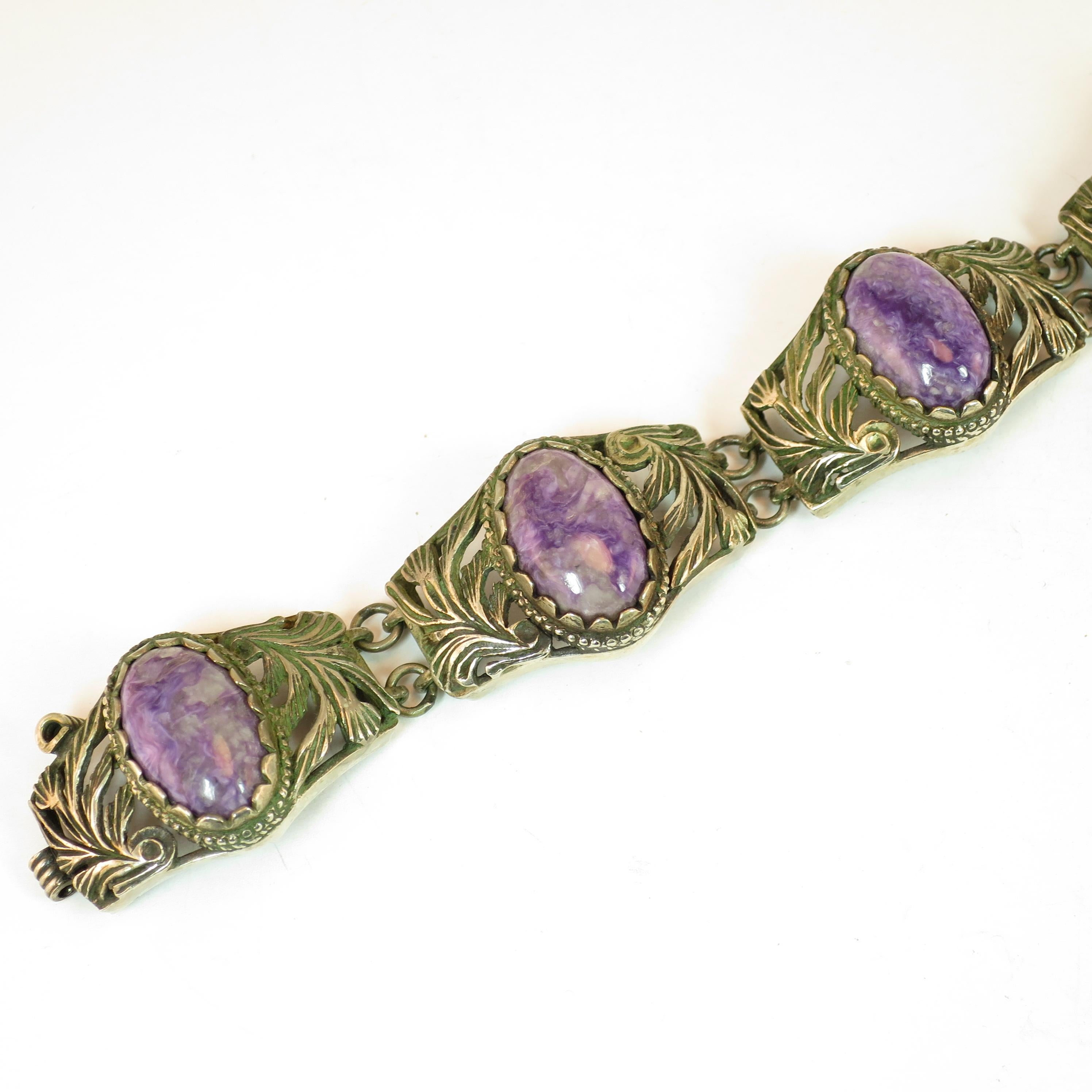 Offered here is a Mid-Victorian link bracelet of Chinese export silver and amethyst from the 1860s. The five curved links are joined by double o-rings; each link is centered with an oval cabochon of polished raw-gem amethyst in a scalloped bezel