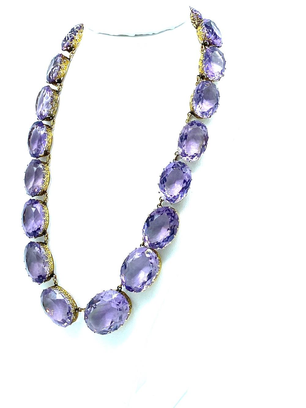 Amethyst 100 Carat Necklace 14 Karat Gold
15 Inch long plus a large 8.32 mm 14 karat gold spring ring clasp,
Blush colored purple amethyst gemstones graduate in size from the largest center stone measuring 21.50 x 16.86 mm.  Each stone is slightly