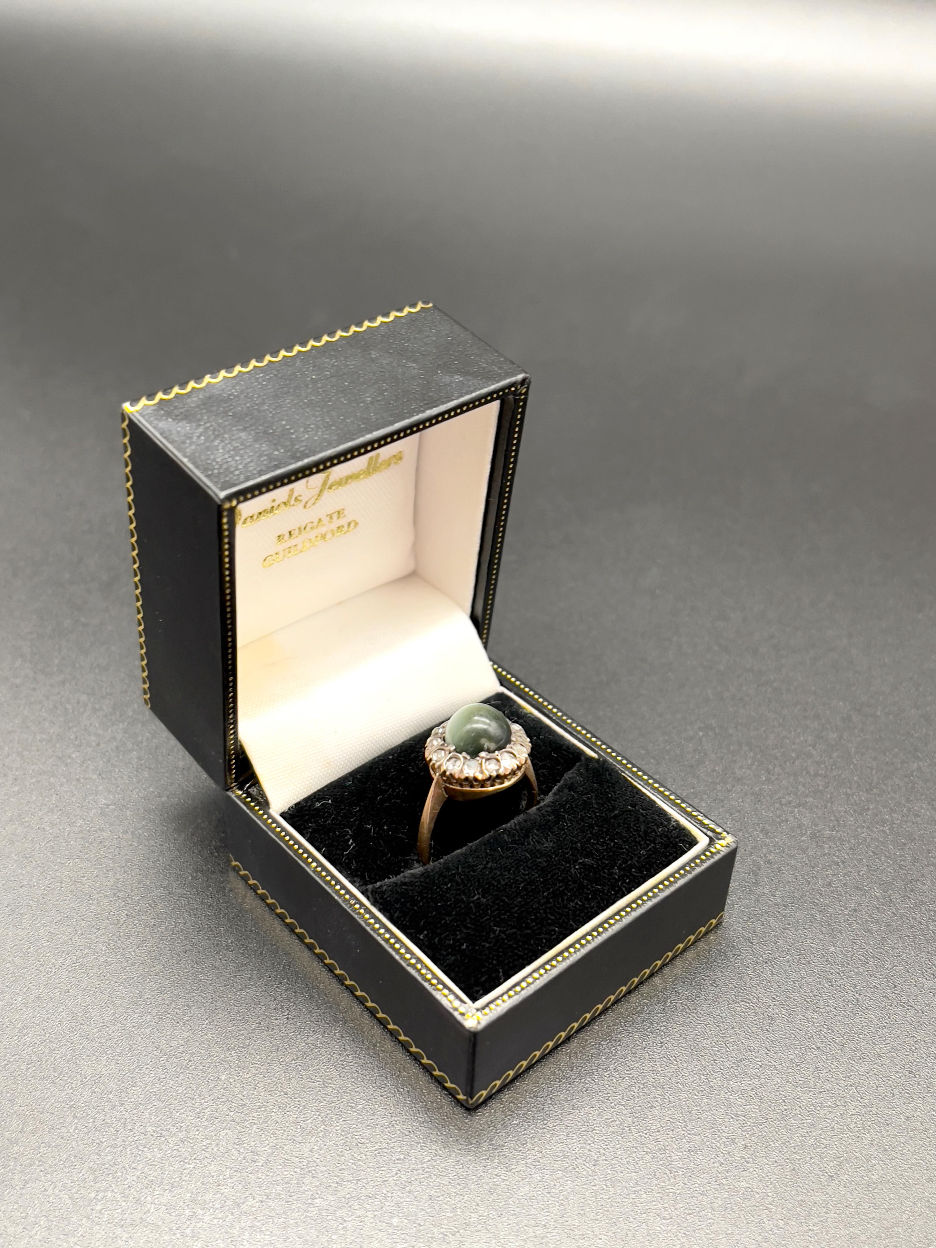 A Stunning Late Nineteenth Century Cat's Eye Chrysoberyl Cabochon  sorrounded by Old European Cut Diamonds, a  guaranteed  head-tuner.  

Exquisitely made in 19.2 Karat Portuguese gold, and with 13 Old European Cuts diamonds circa 0.80 Carats. 