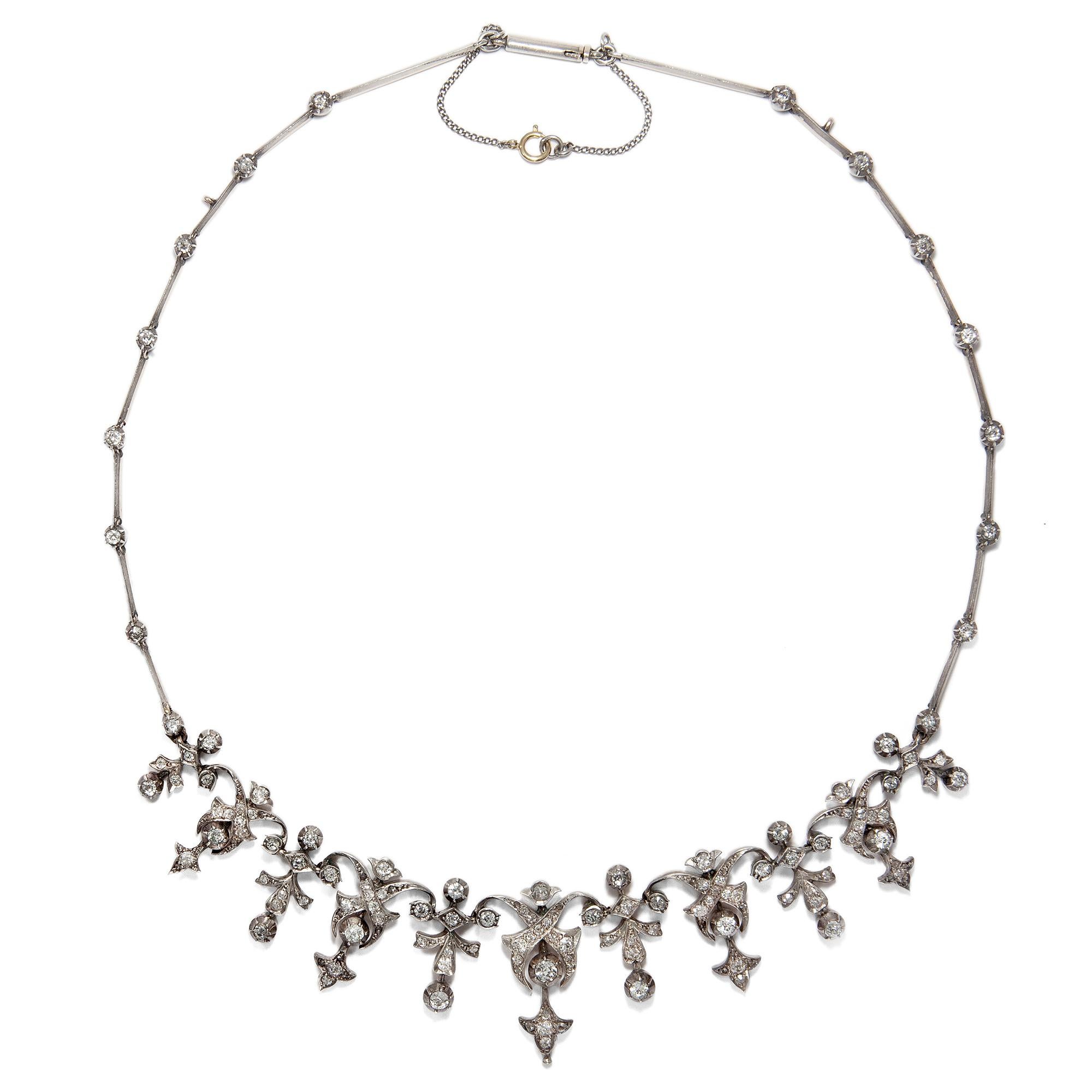 The splendid diamond necklace at hand was fashioned in the late 19th century. Its creator's goal was to let the diamonds appear as bright and glistening as possible, using the latest techniques of his time. 

White gold had not yet been invented,
