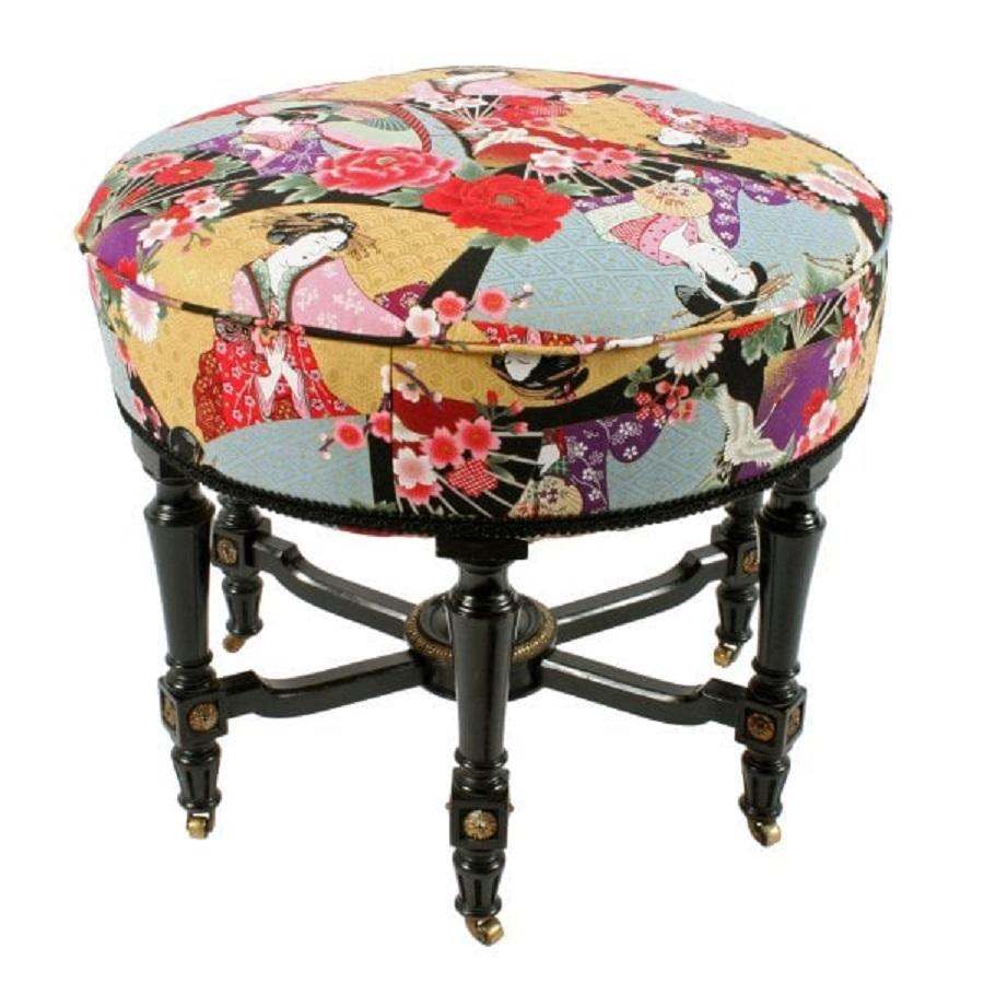 A late 19th century Victorian ebonised circular stool.

The stool stands on six turned legs that are joined by a shaped cross stretcher with a central boss.

The legs are decorated with gilt patera and the stool is raised on six gilt brass