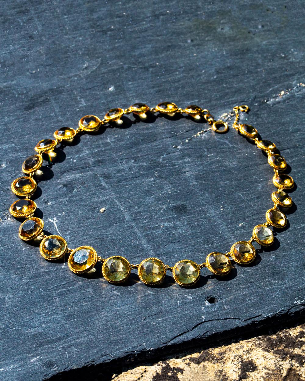 This gorgeous necklace holds 25 stones all set in rope twist detailed settings modelled in 18ct gold. The stones stray with larger at the centre and get smaller towards the clasp. The largest diameter is a 17mm and the smallest is 11mm. 

Length: