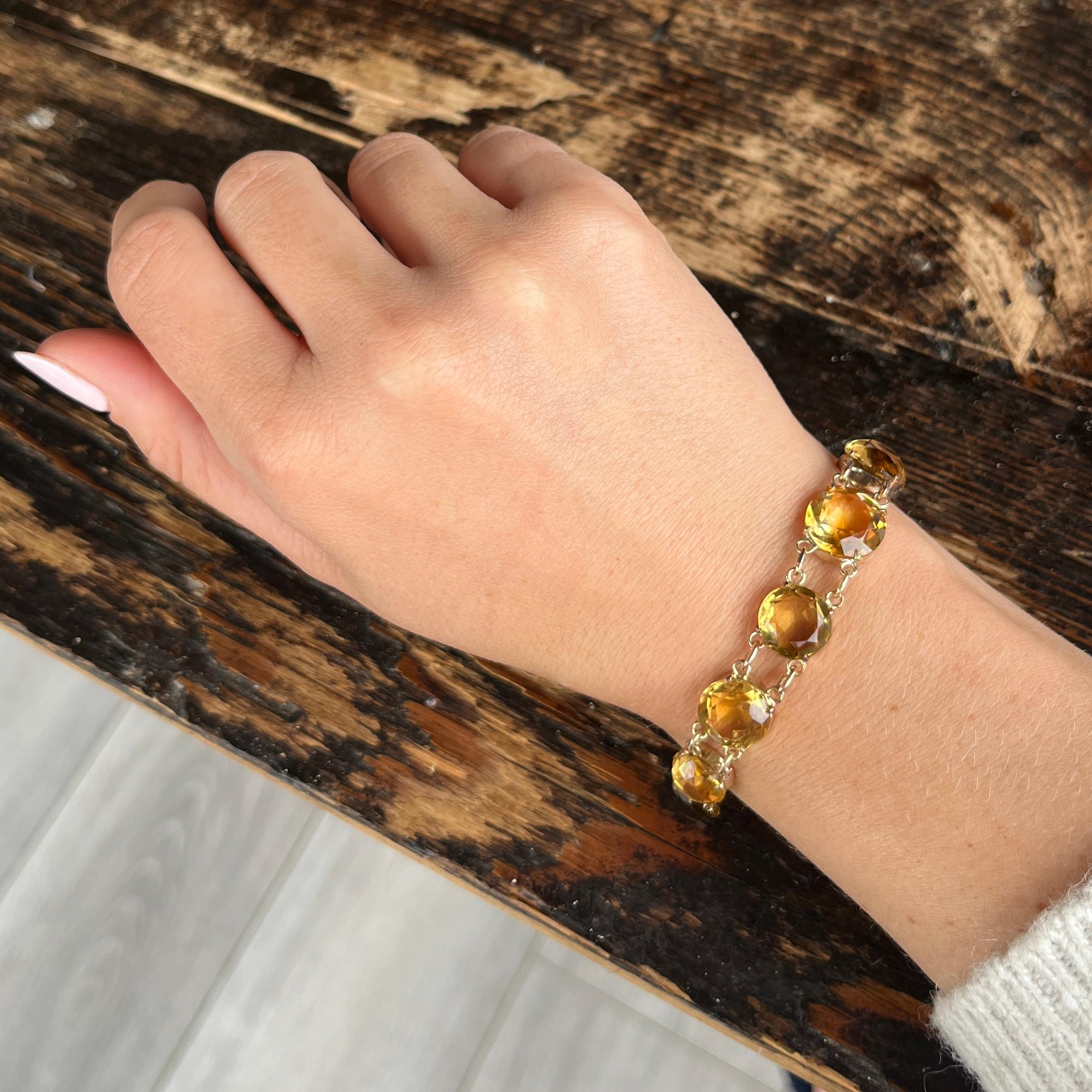 This sweet bracelet holds 11 yellow citrine stones. This piece is dated to the victorian era and is modelled in 9carat gold. 

Length: 19cm
Stone Diameters: 12mm to 9mm

Weight: 17.8g