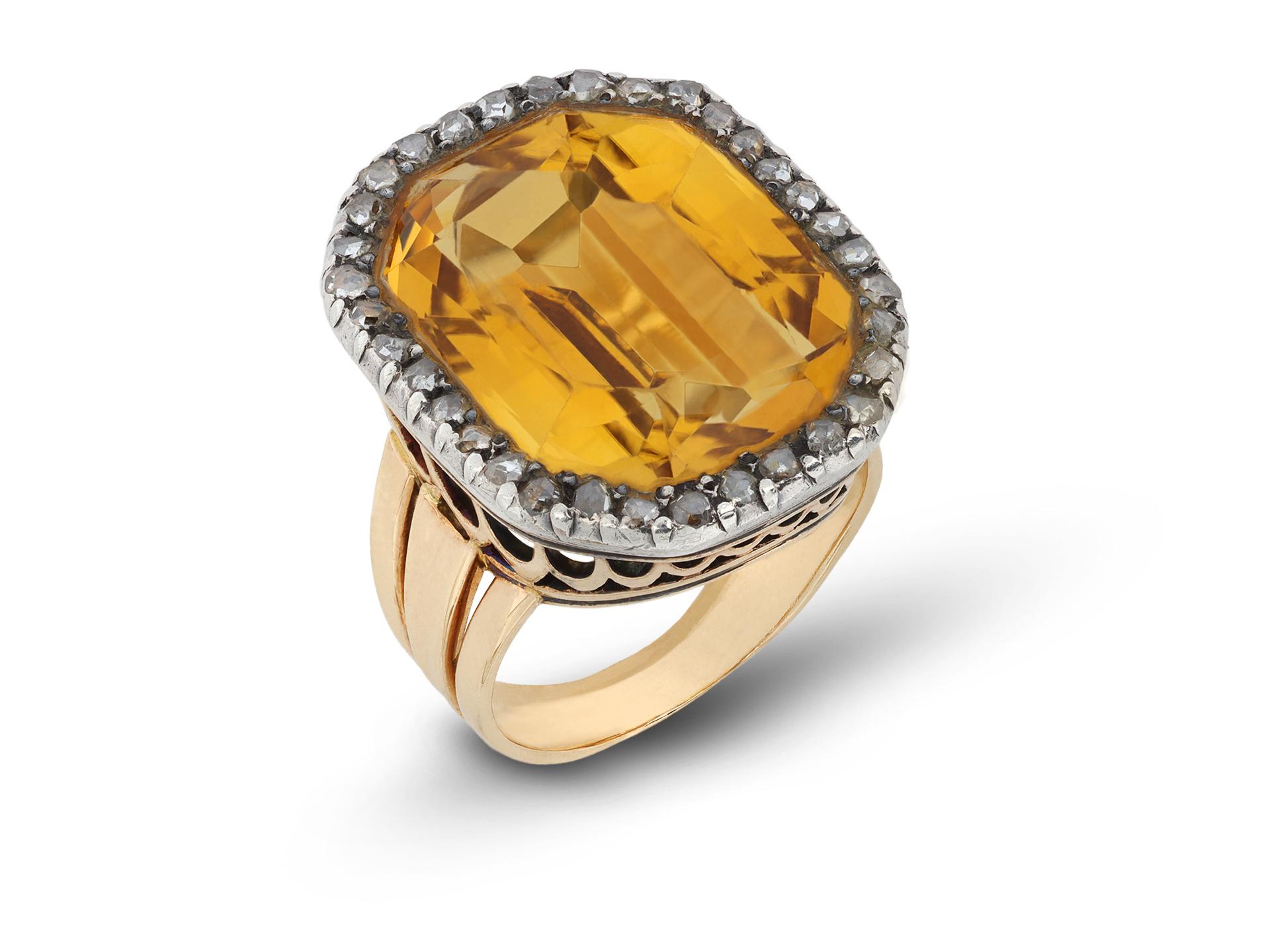Victorian citrine and diamond coronet cluster ring. Centrally set with an octagonal step-cut natural citrine in an open back grain setting with an approximate weight of 17.00 carats, surrounded by thirty four round rose cut diamonds in closed back