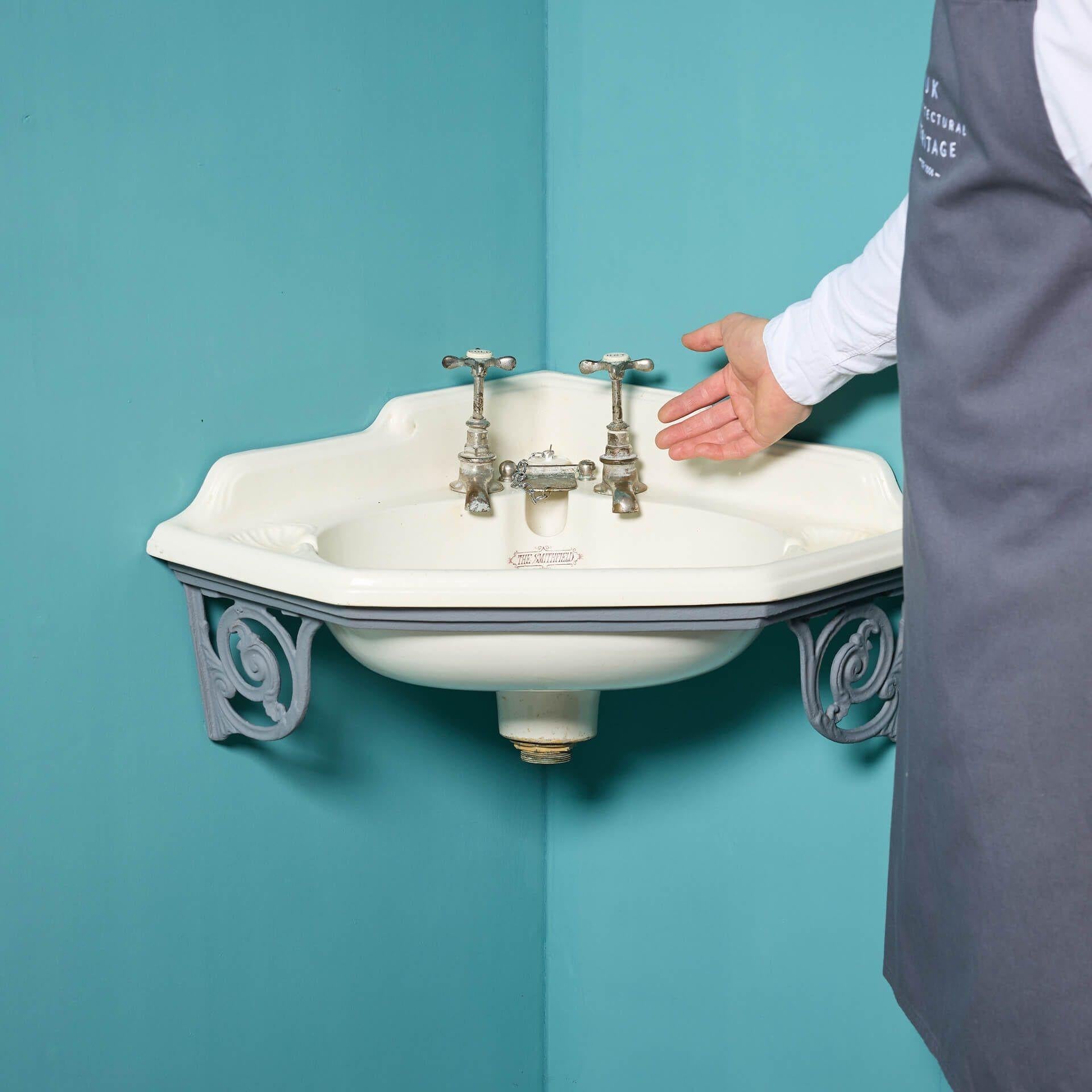An original Victorian cloakroom porcelain corner sink with scrolling cast iron bracket, circa 1880.

Titled ‘The Smithfield’, this model is petite in size, making it ideal for a vintage w/c or period style cloakroom. This antique basin features